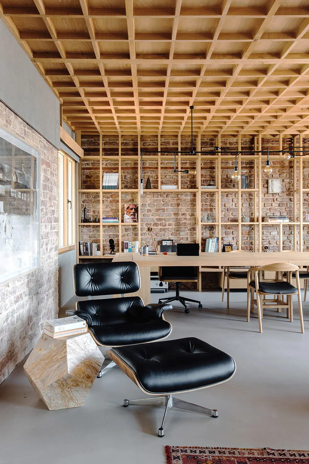 Leather lounge chair and footstool in front of the library wall