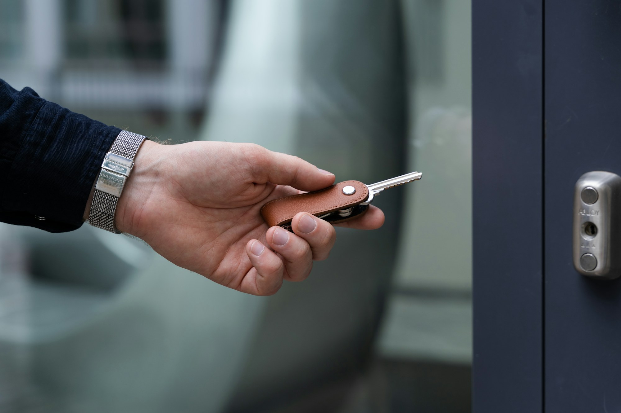 A member holding a key fob up to a door reader