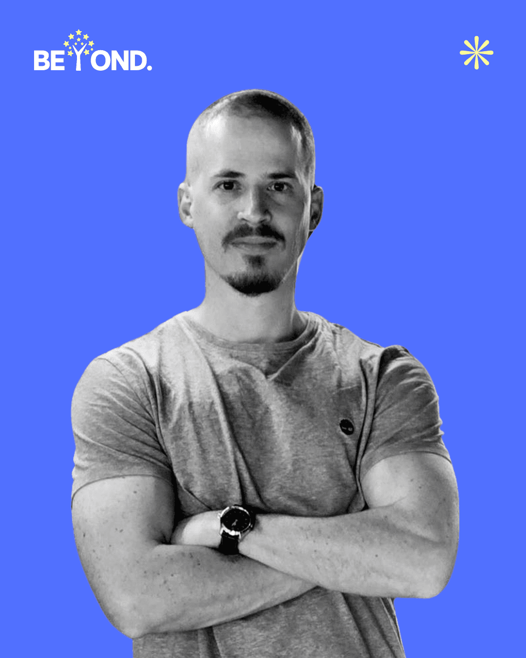 A confident person with short, styled hair and a leather jacket poses against a dark backdrop.