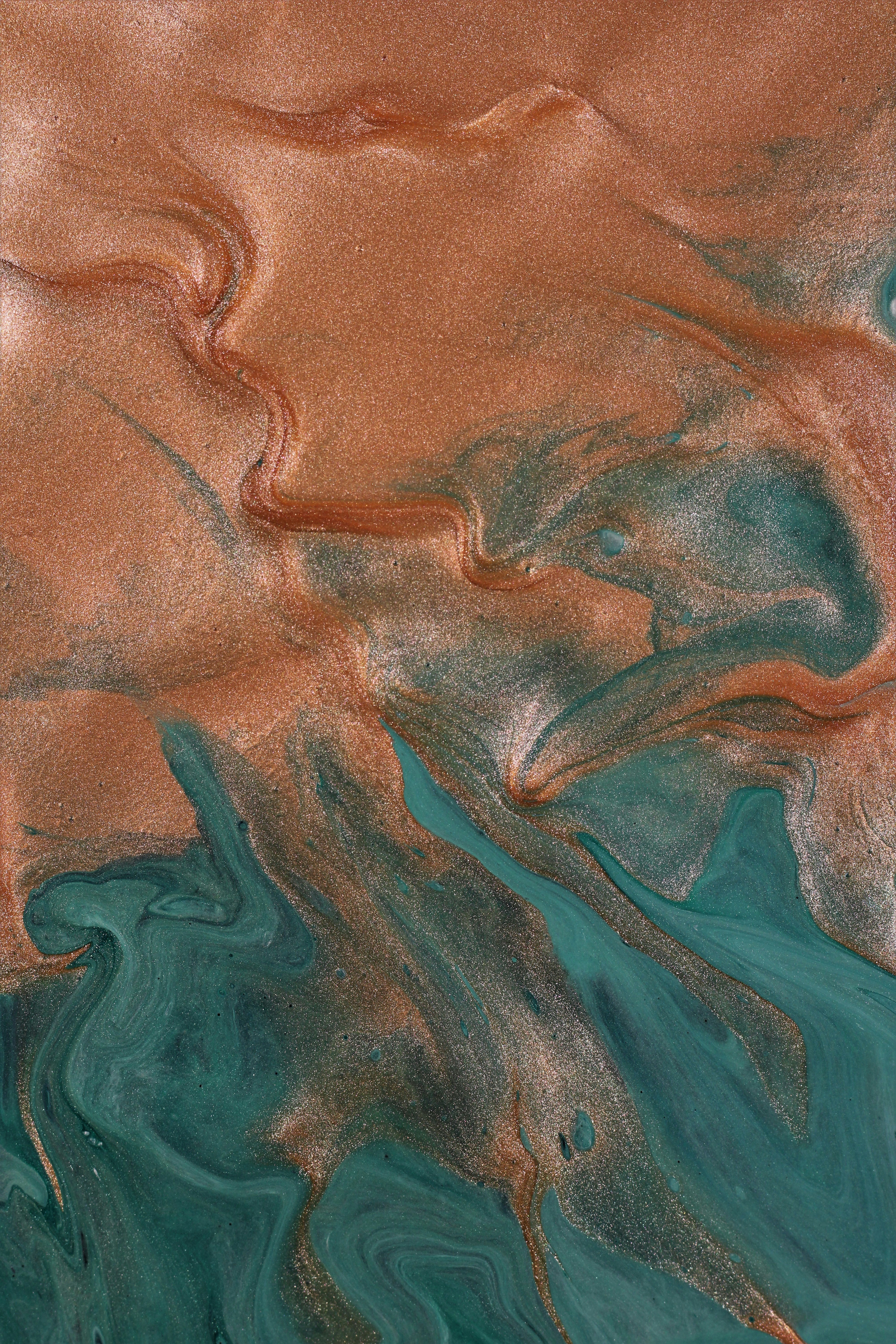a close up of a water surface with brown and blue colors
