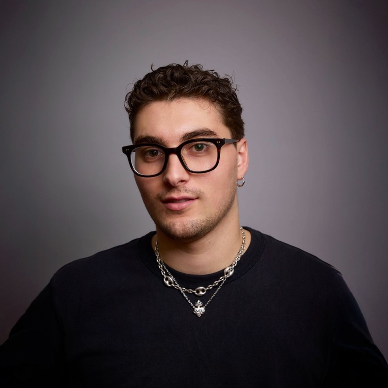 man in white crew neck shirt wearing black framed eyeglasses