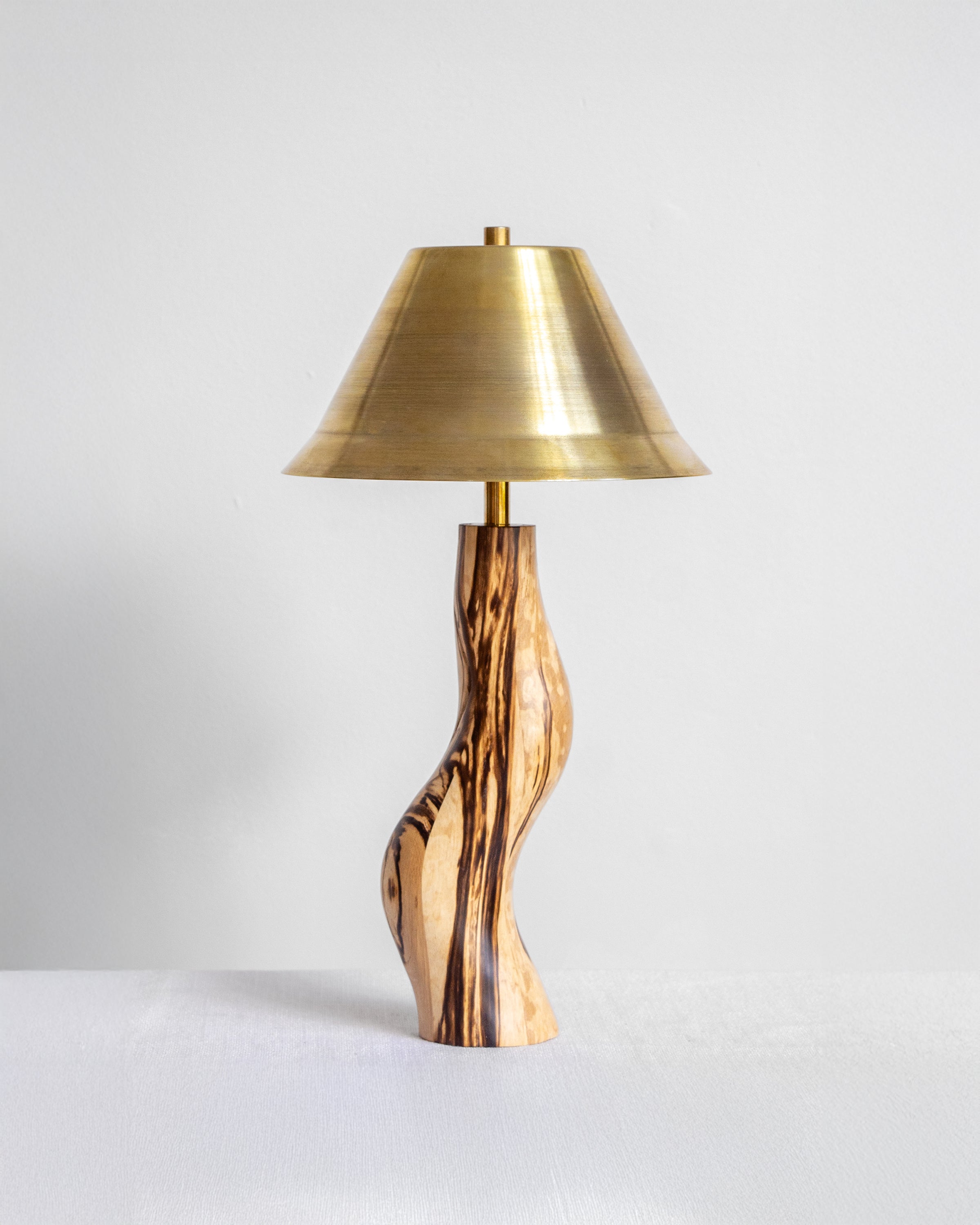Dancing Desk Lamp with Spalted timber base and Brass shade on a light grey background with UK, EU and US/CA wiring available Wilkinson & Rivera