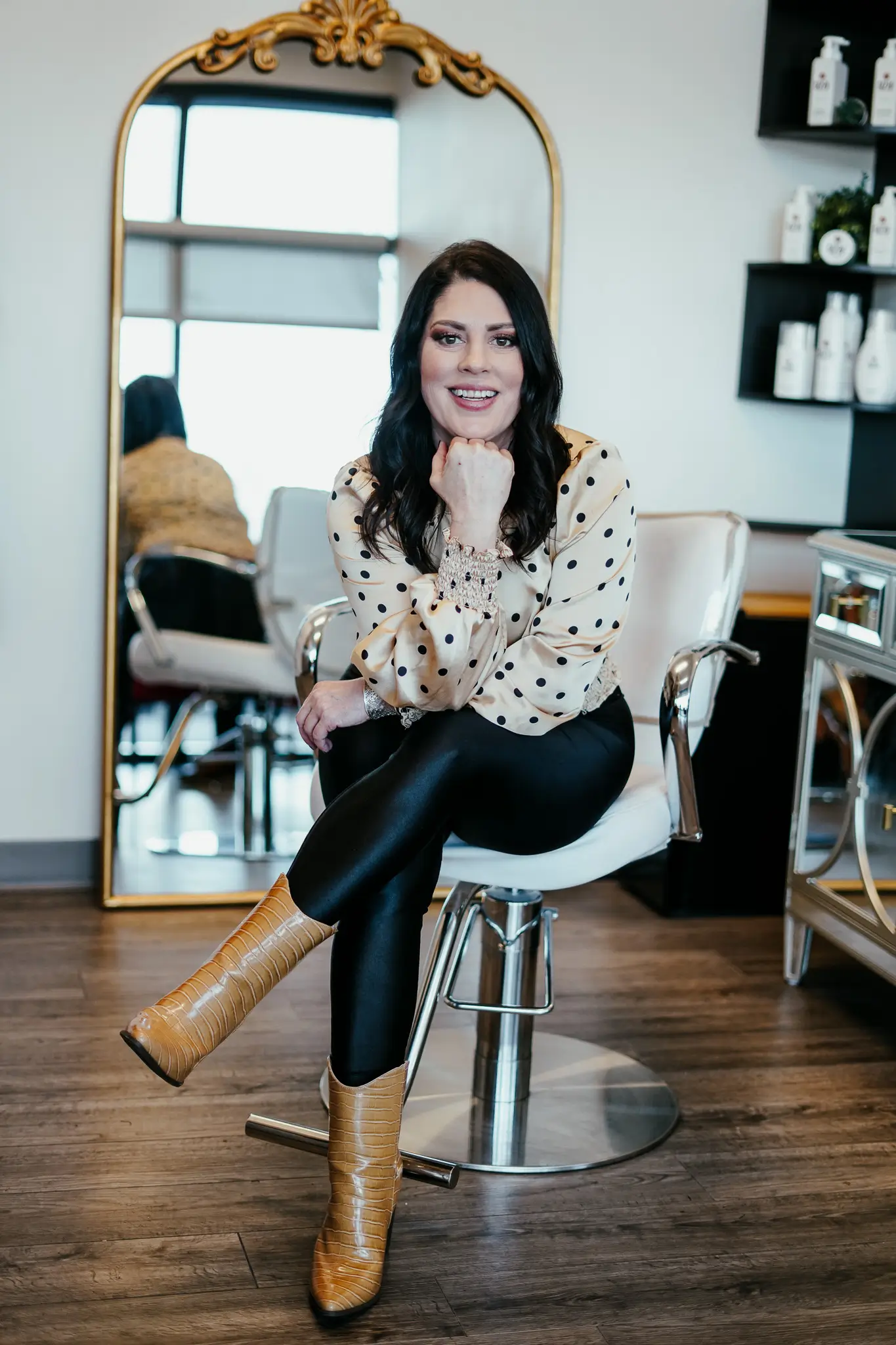 An image of Tasha Smith, owner of Style Me Up, sitting in a salon chair.