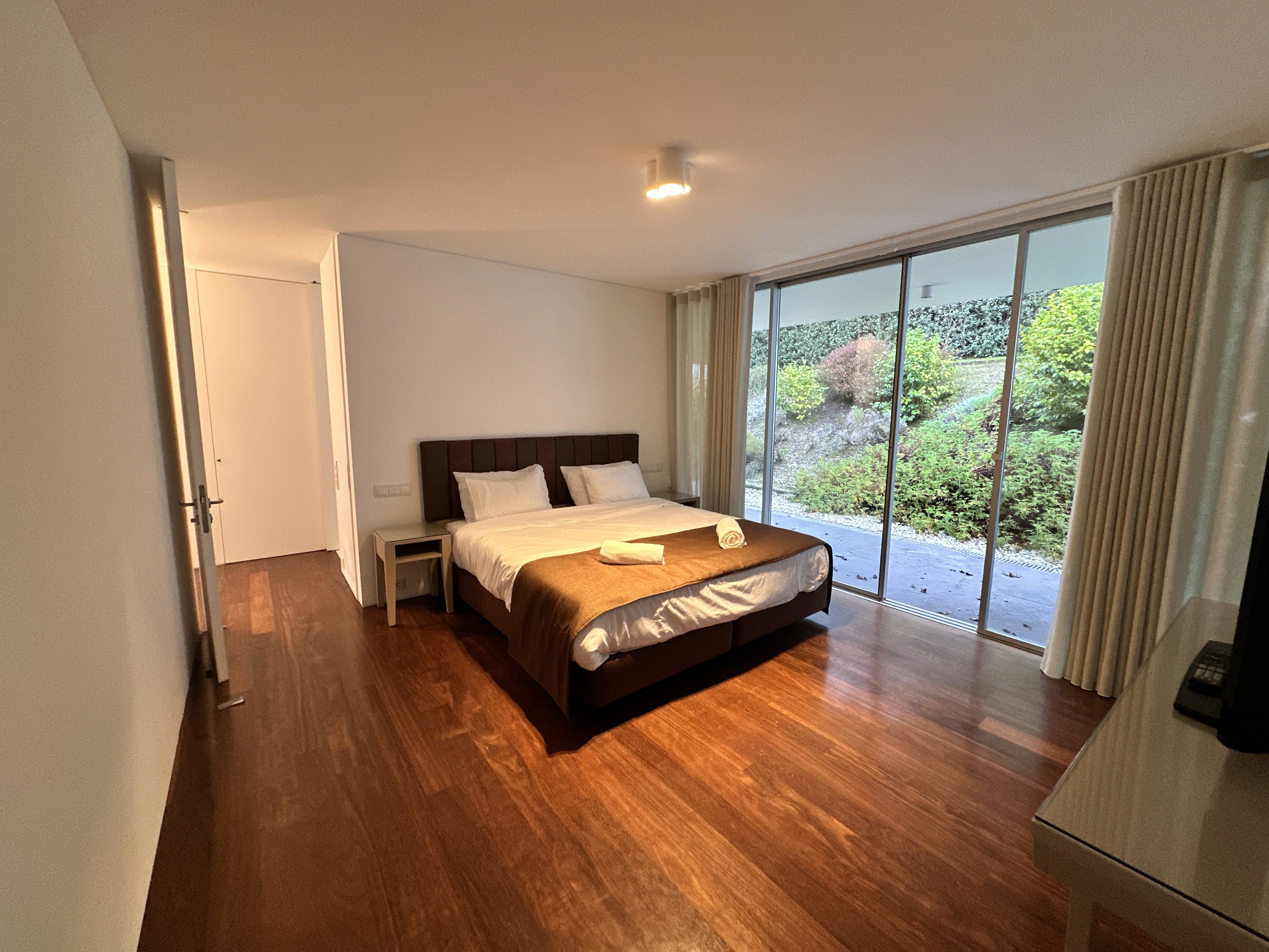 Modern hillside home with terracotta urn and mountain view