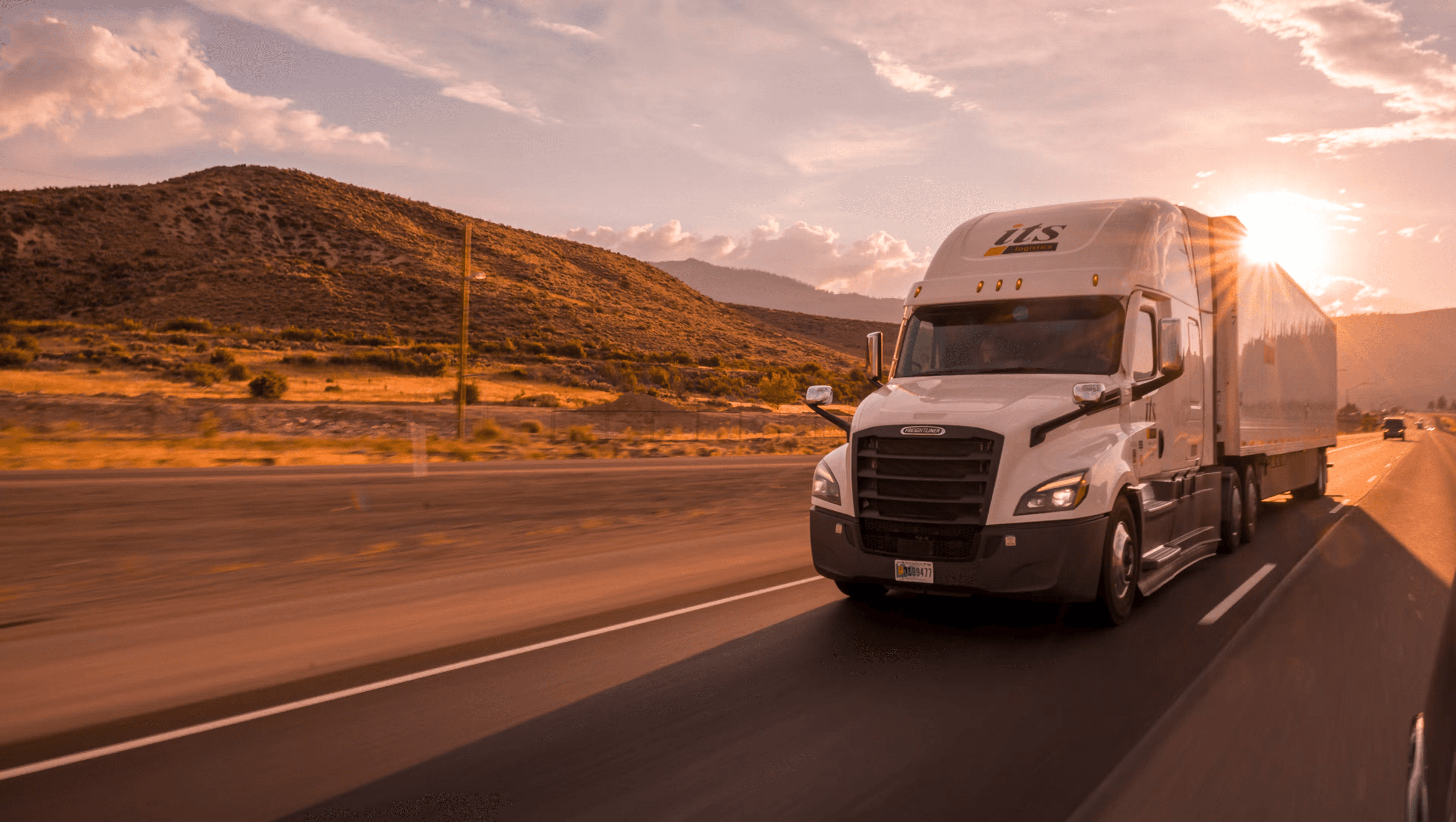 Semi-truck hauling goods with freight brokerage office in the background representing broker transparency discussions.