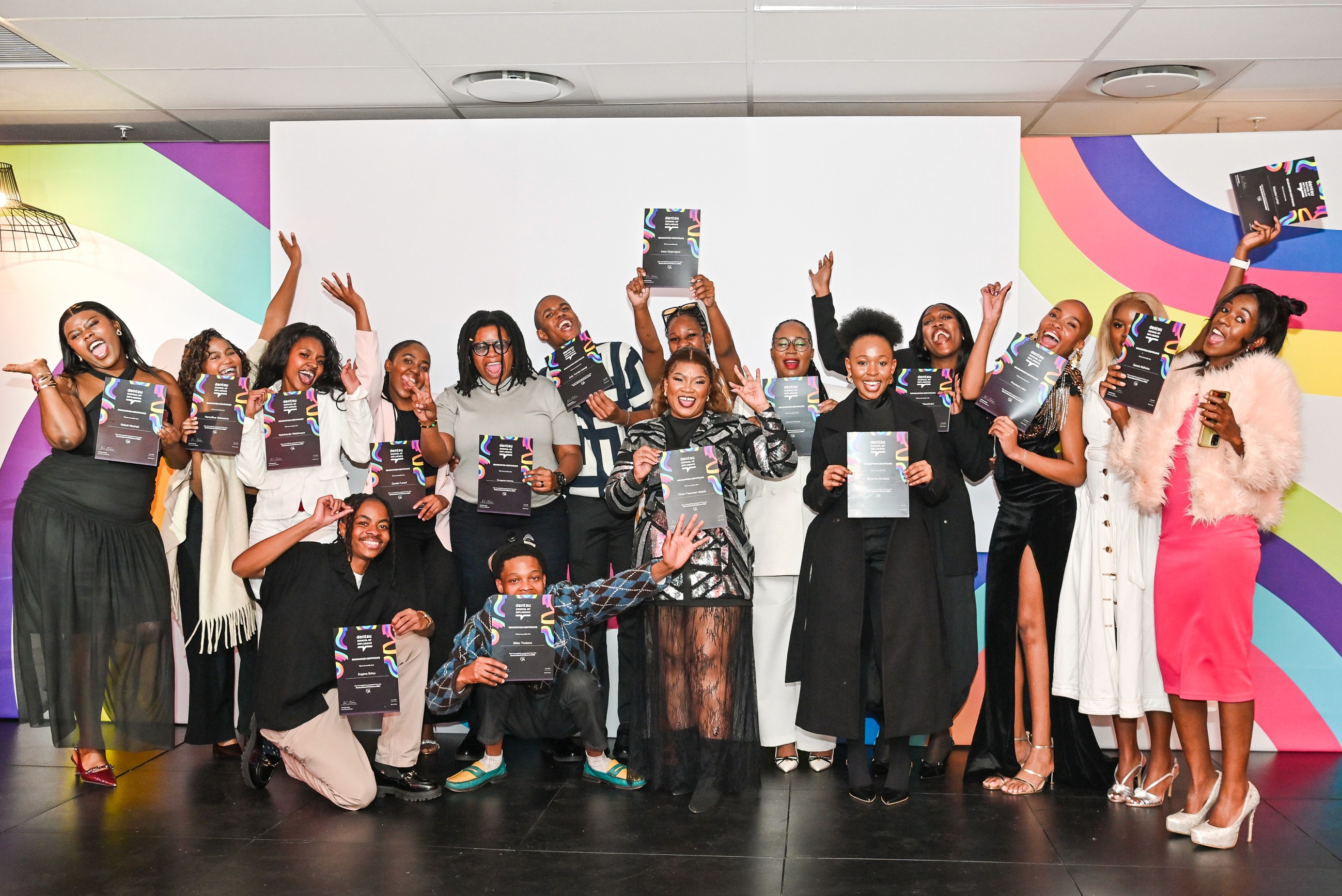 2026 Dentsu School of Influence cohort standing on the Dentsu Creative stage with their certificates