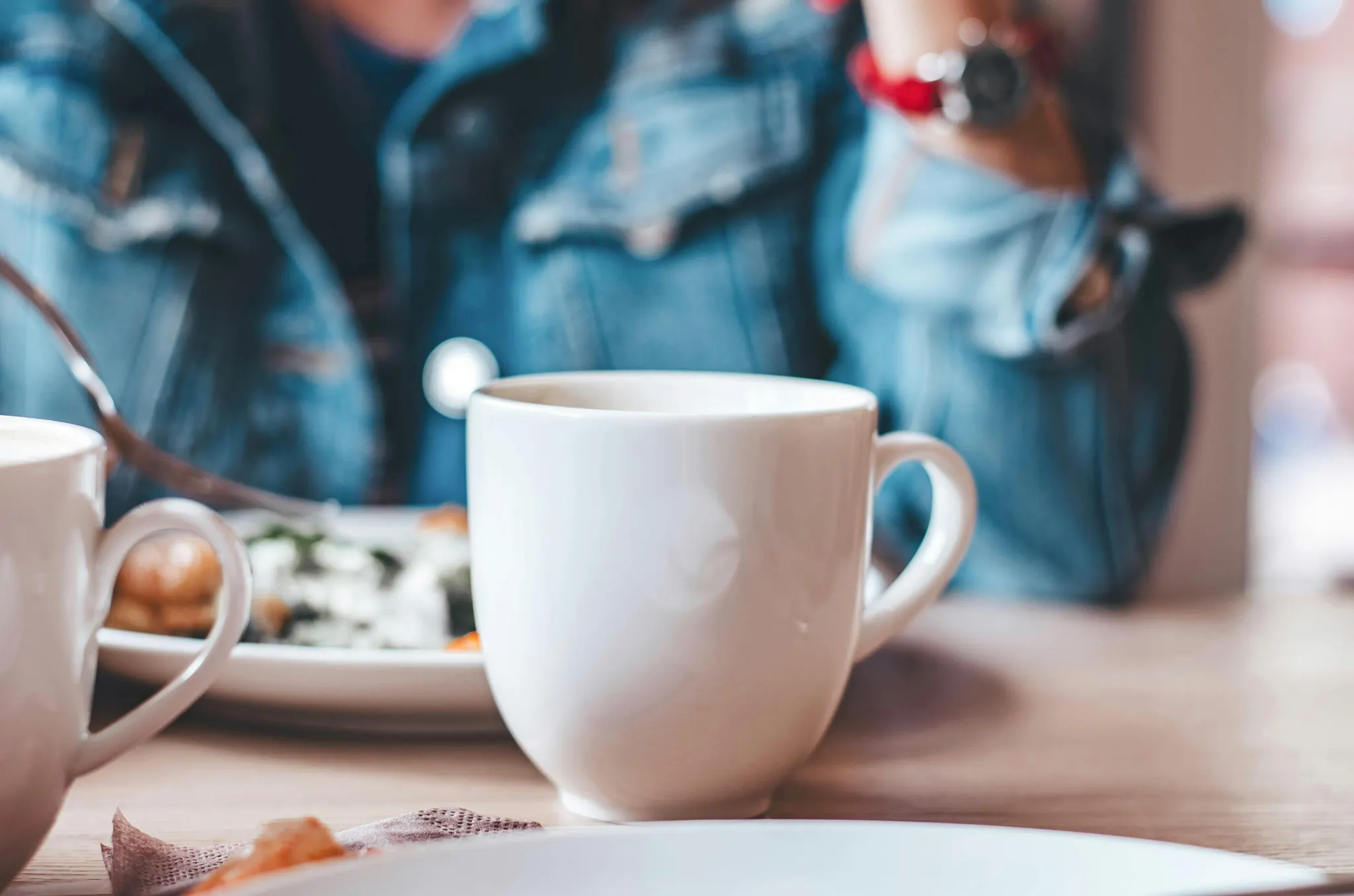 A cup of coffee sits on a table durring a supervision meeting