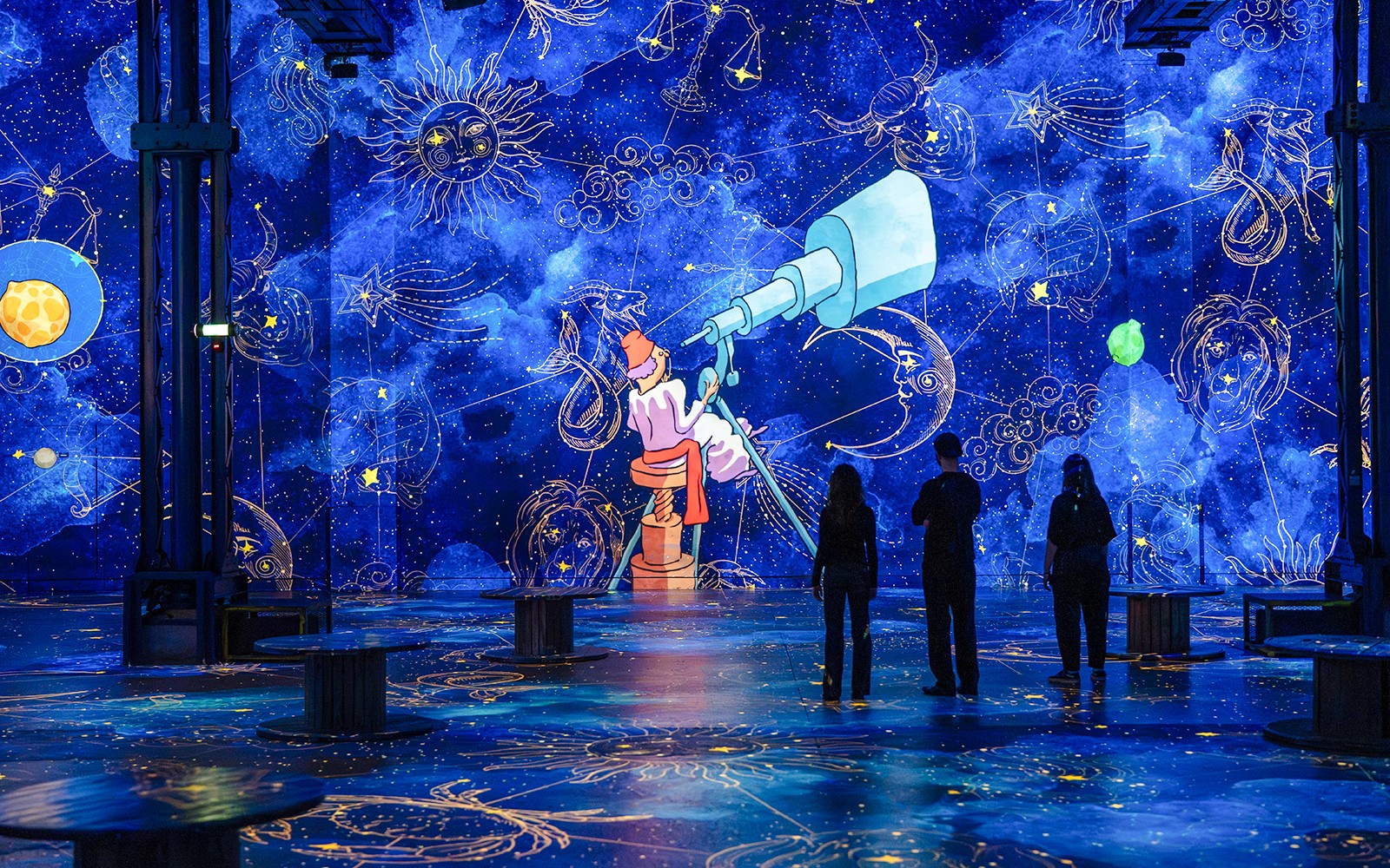 Immersive digital exhibition of "The Little Prince" at Atelier des Lumières, Paris, with celestial projections.