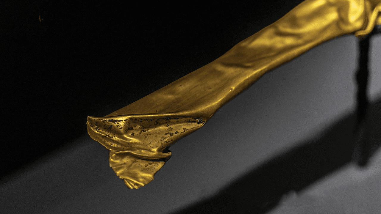 Detailed close-up of the Sanxingdui gold staff with carved patterns