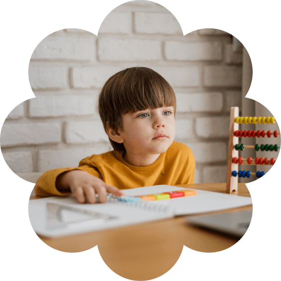Child learning at a desk inside a flower shape