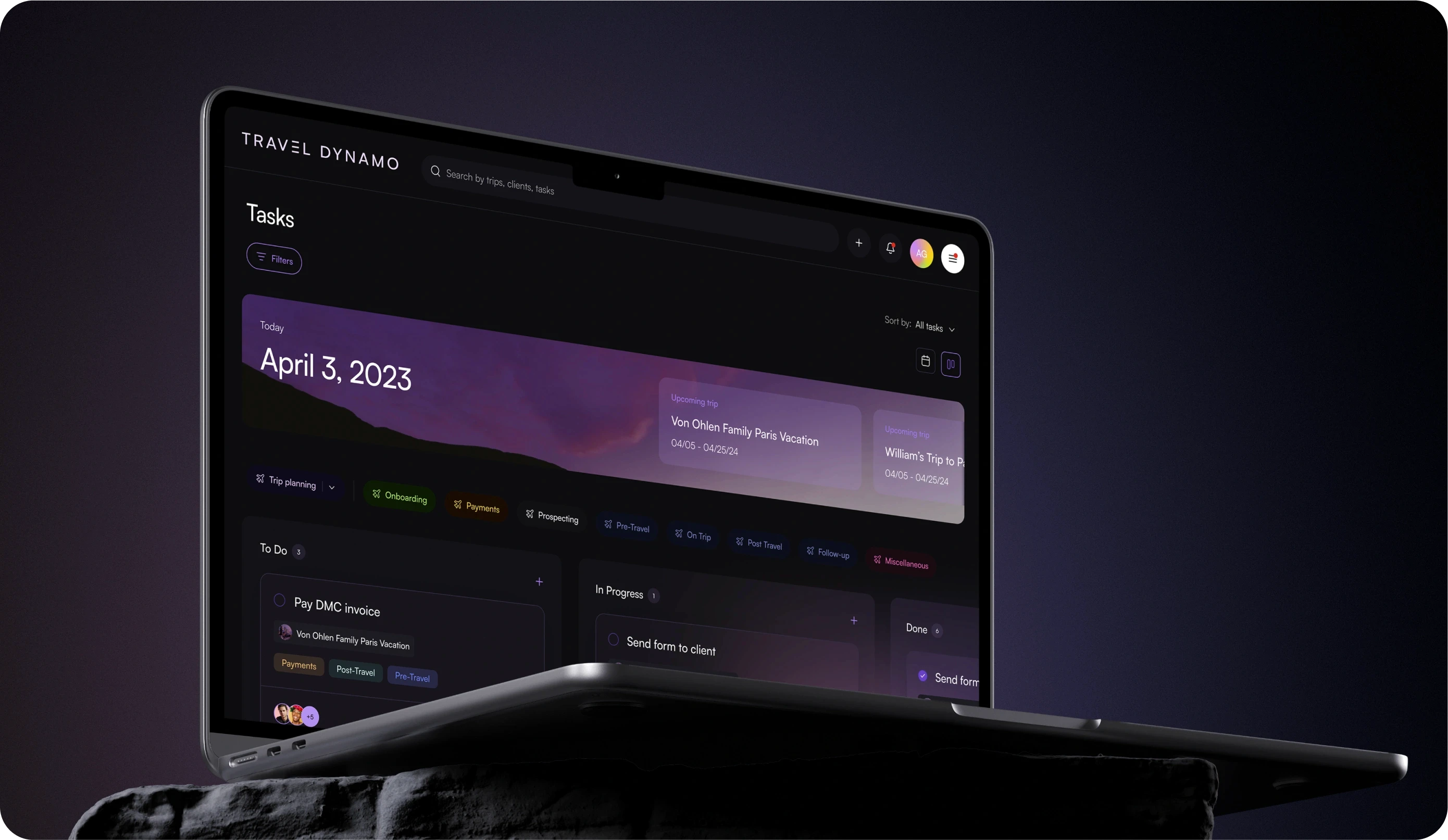 Image of a laptop screen displaying the 'Travel Dynamo' task management interface, focused on tasks for April 3, 2023. The screen shows various tasks under categories like 'To Do', 'In Progress', and 'Done' on a sleek dark theme interface with purple highlights. Featured tasks include 'Pay DMC invoice' and 'Send form to client' related to the Von Ohlen Family Paris Vacation, with visible user avatars and task statuses. The design is modern and user-friendly, aimed at facilitating the organization of travel-related tasks.