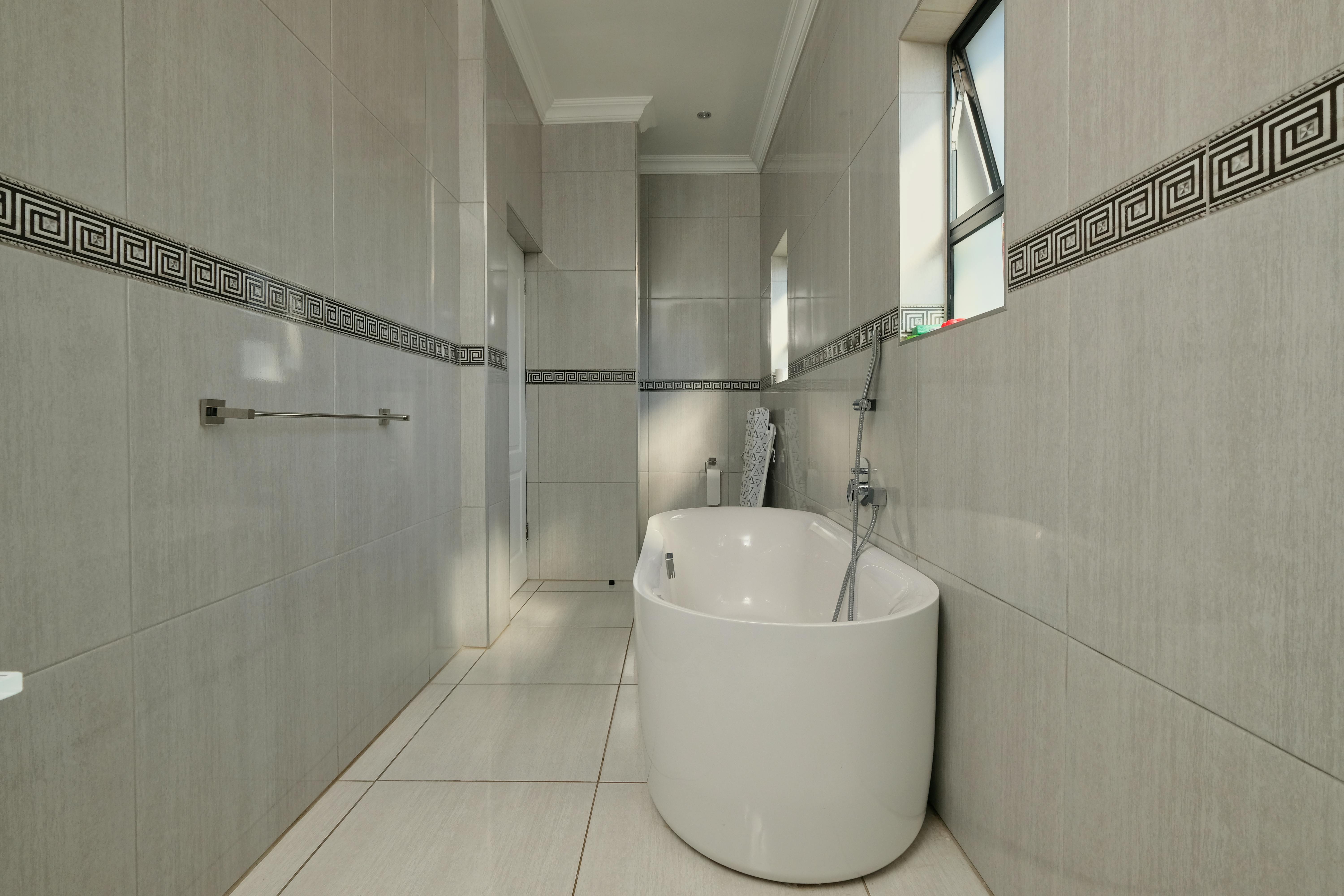 white ceramic toilet bowl near vanity combo