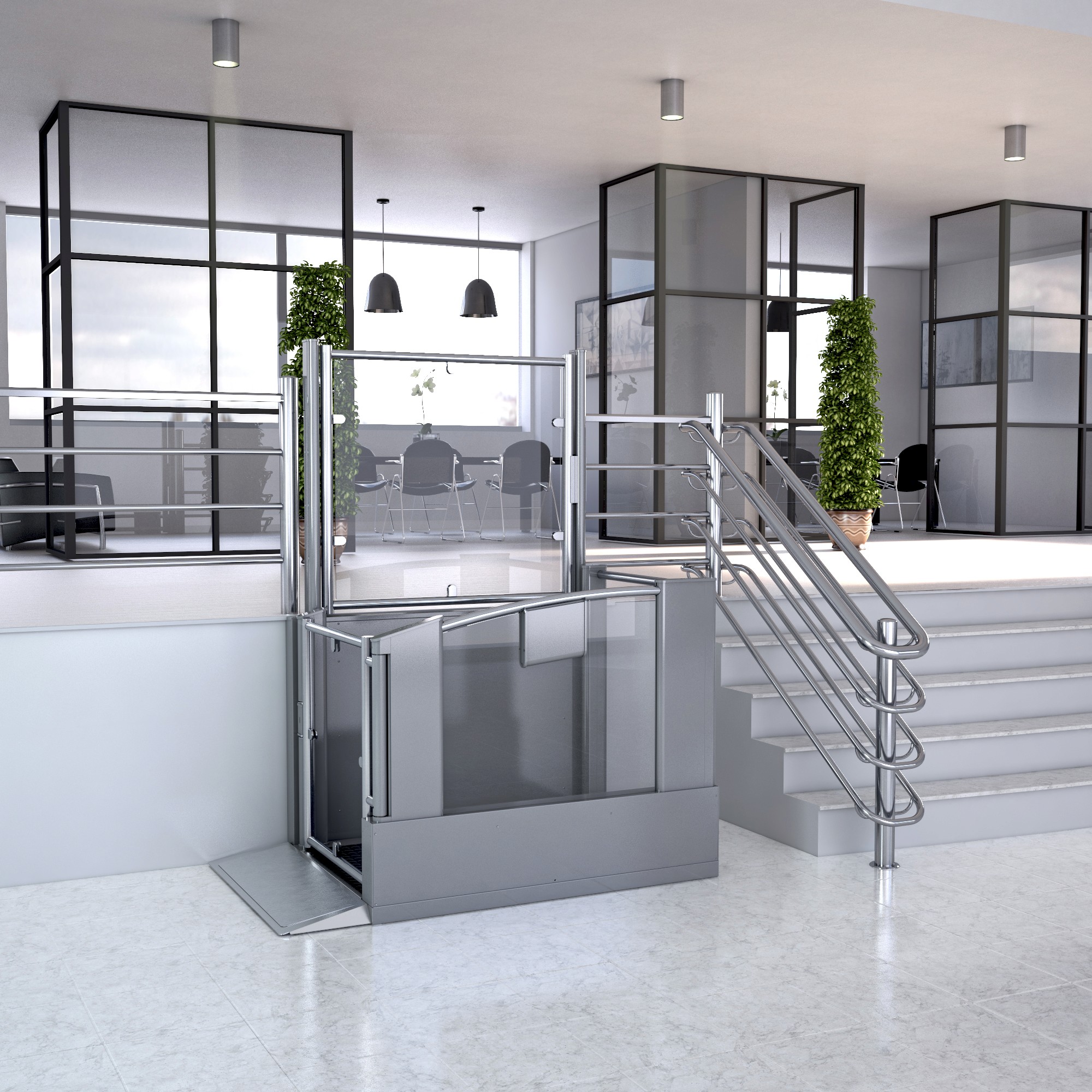 Commercial vertical platform lift with glazed enclosure installed beside staircase in a modern office building — stainless steel frame with door open at lower landing level