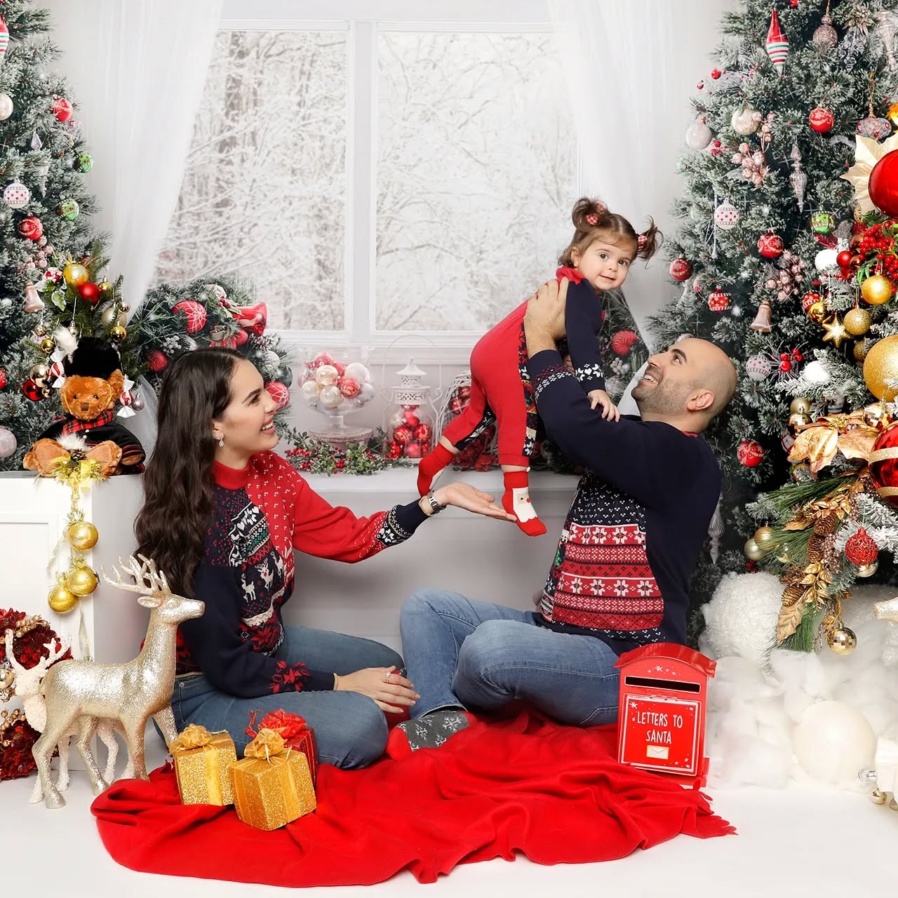 A family wearing matching outfits for their Christmas Photos, featured in a family photoshoot in Dubai by Mahvin Photography.