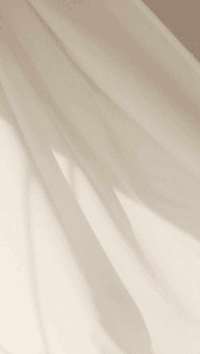 Intricate folds of beige silk satin material, highlighting the premium drape and feminine elegance of high-end evening wear.