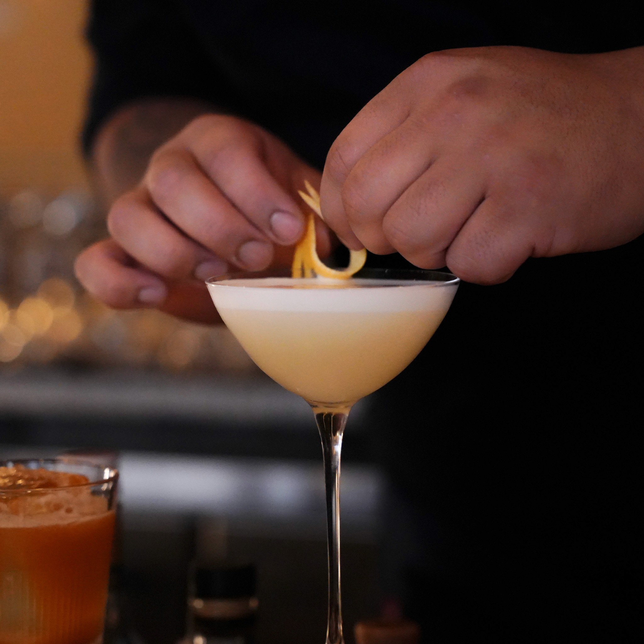 Man sits looking up at a beautiful, cloudy sky.
