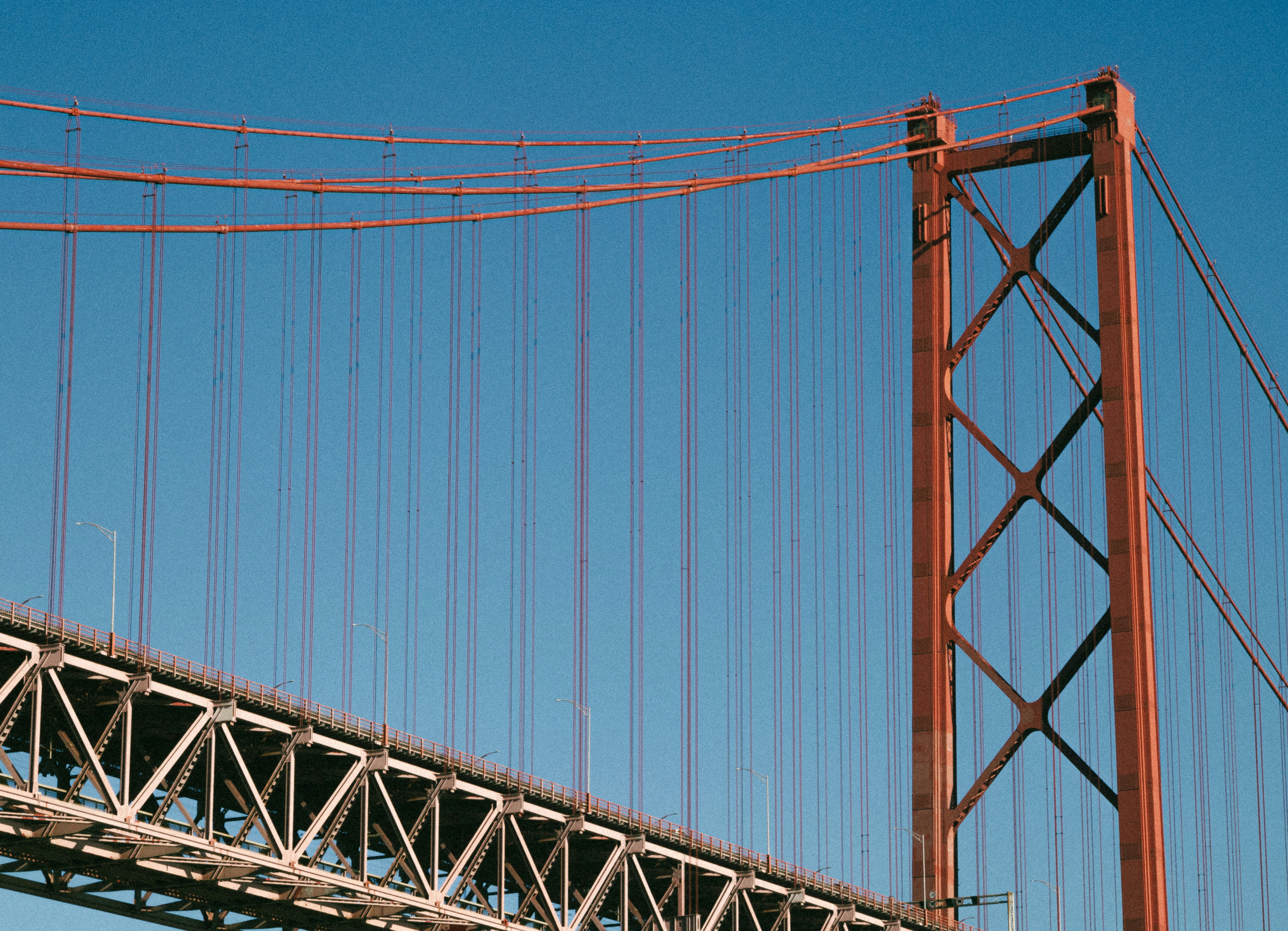 Close-up of a suspension bridge tower and cables