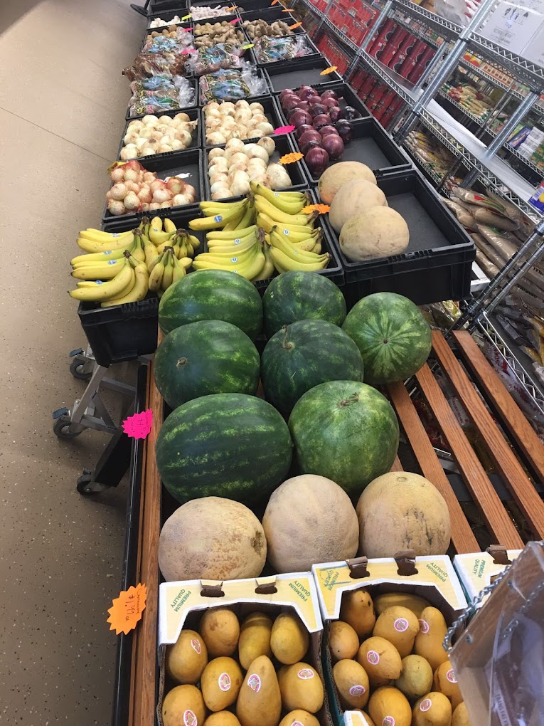 Fresh melons, bananas, and onions displayed in the produce section at International Food Market Orlando, your go-to ethnic grocery store in Orlando for fresh and exotic produce.