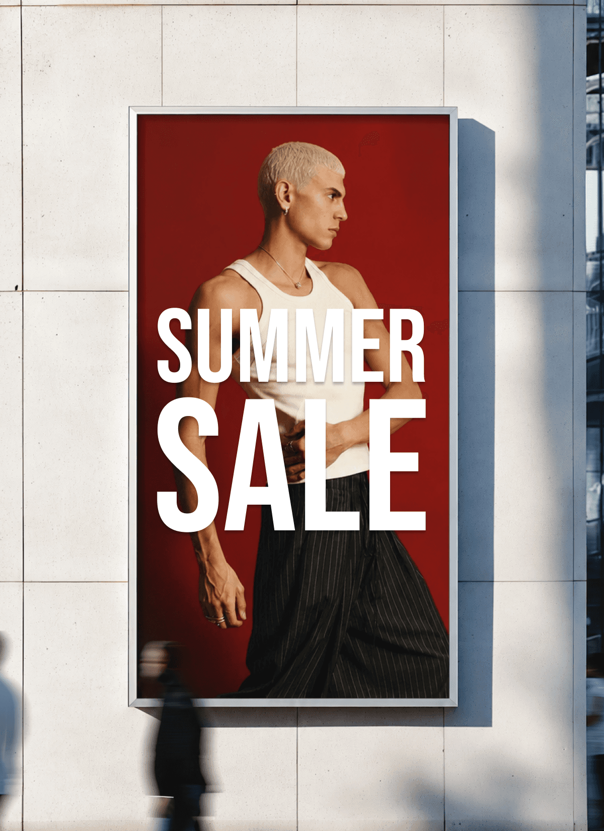 A “Summer Sale” campaign poster displayed on the side of a city building for a marketing campaign section, featuring a male model in a white tank top against a bold red background with a natural, real-world advertising feel.