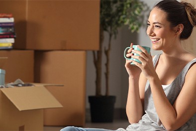 Close-up of lush, dark green leaves, some glossy and wet, against a muted background.