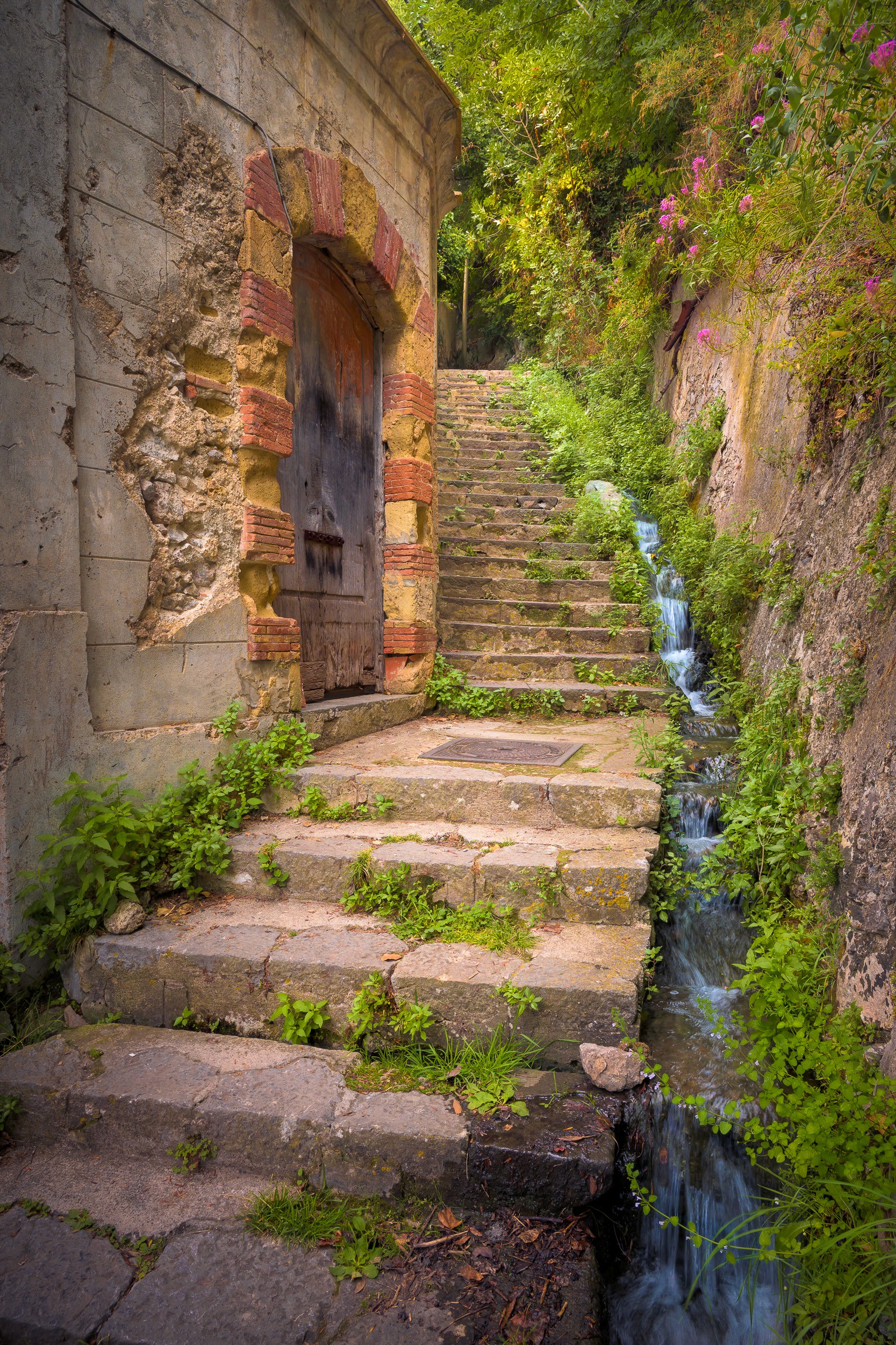 The infinite stairs of the Amalfi Coast showcasing a unique door and waterway on the side.