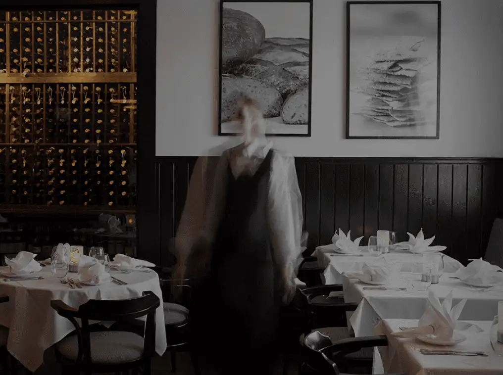 The interior of the dining room in Pain d'Avignon Hyannis showing the dinner table setup