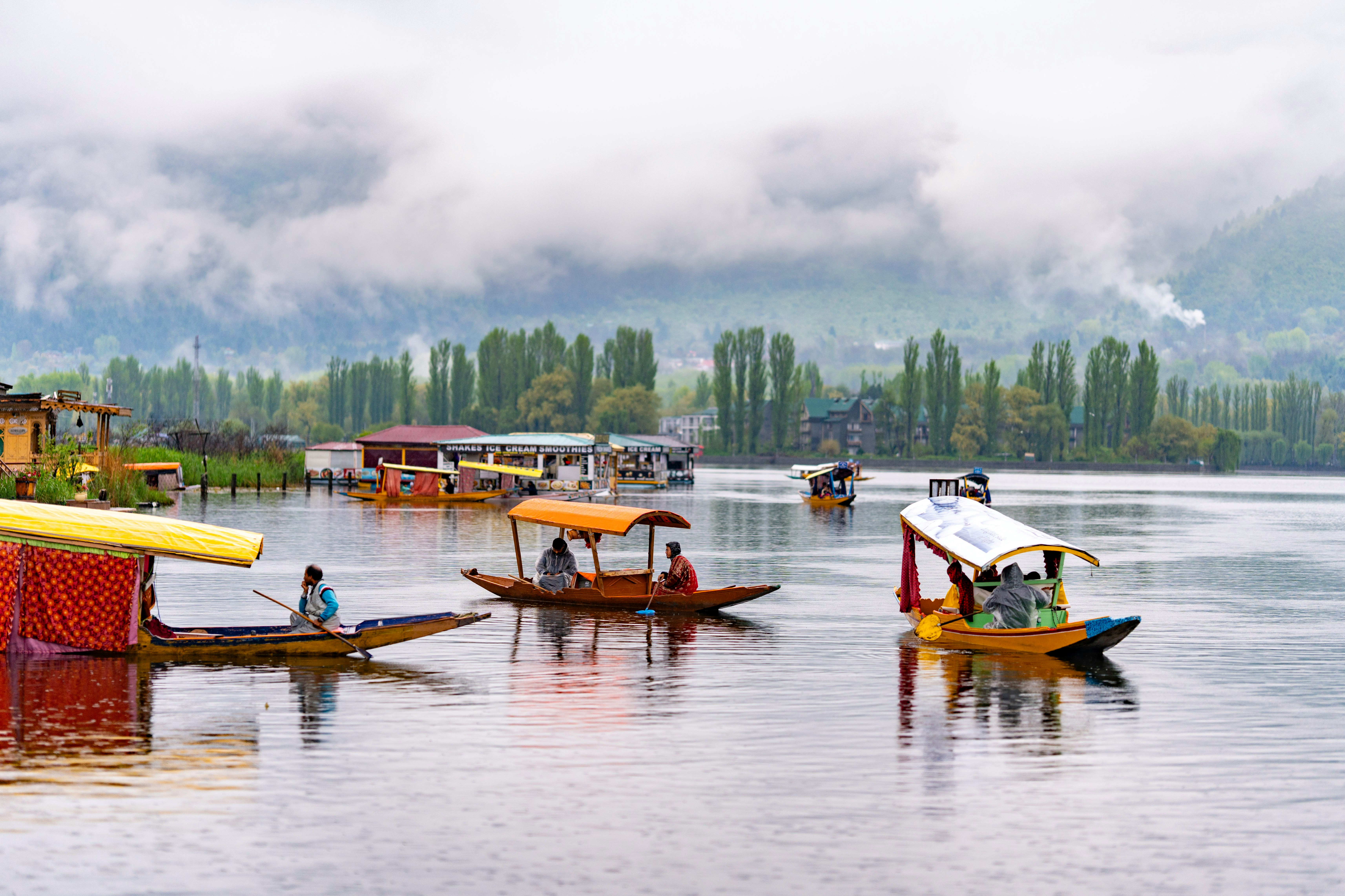 a group of boats floating on top of a lake