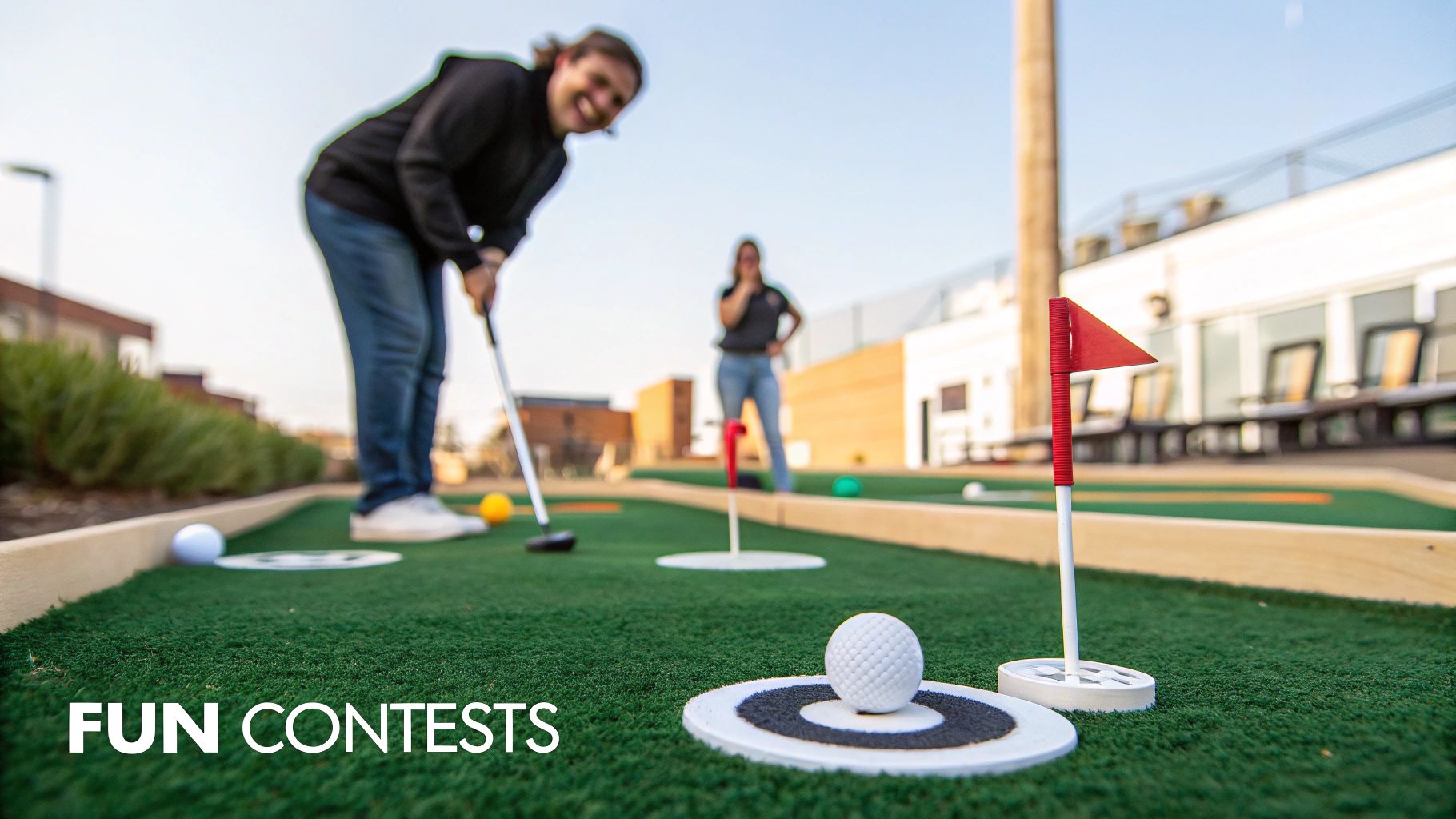 People enjoying a lively game of miniature golf on a sunny outdoor course with multiple holes.