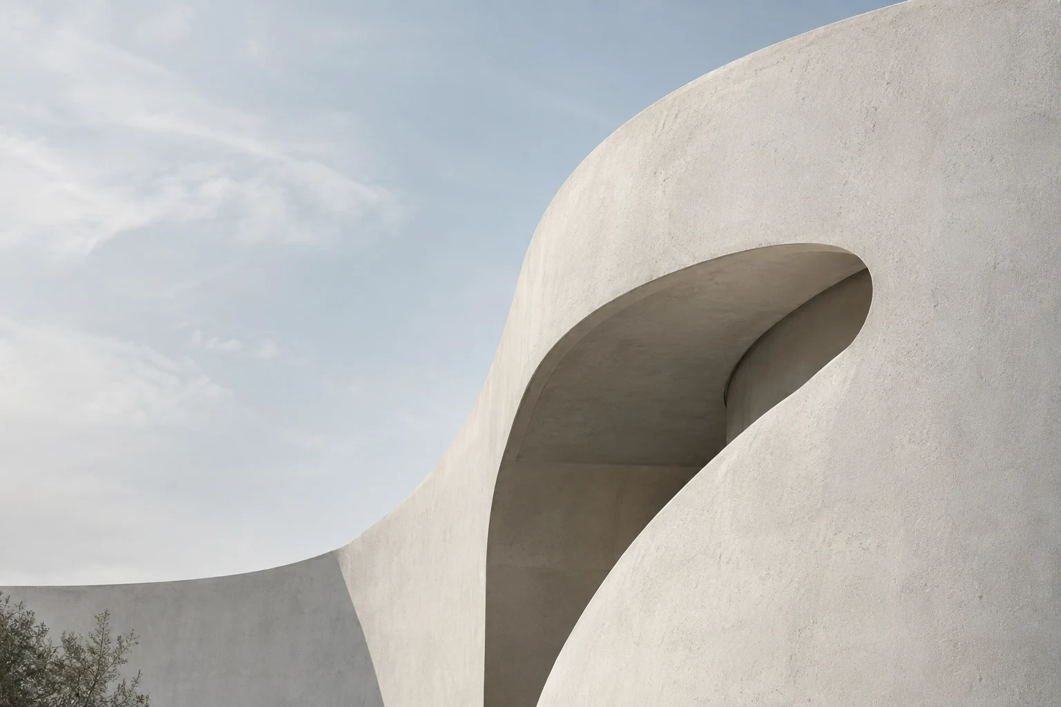 An imaginary flowing white concrete facade with a curved inset opening, abstract architectural detail under pale sky