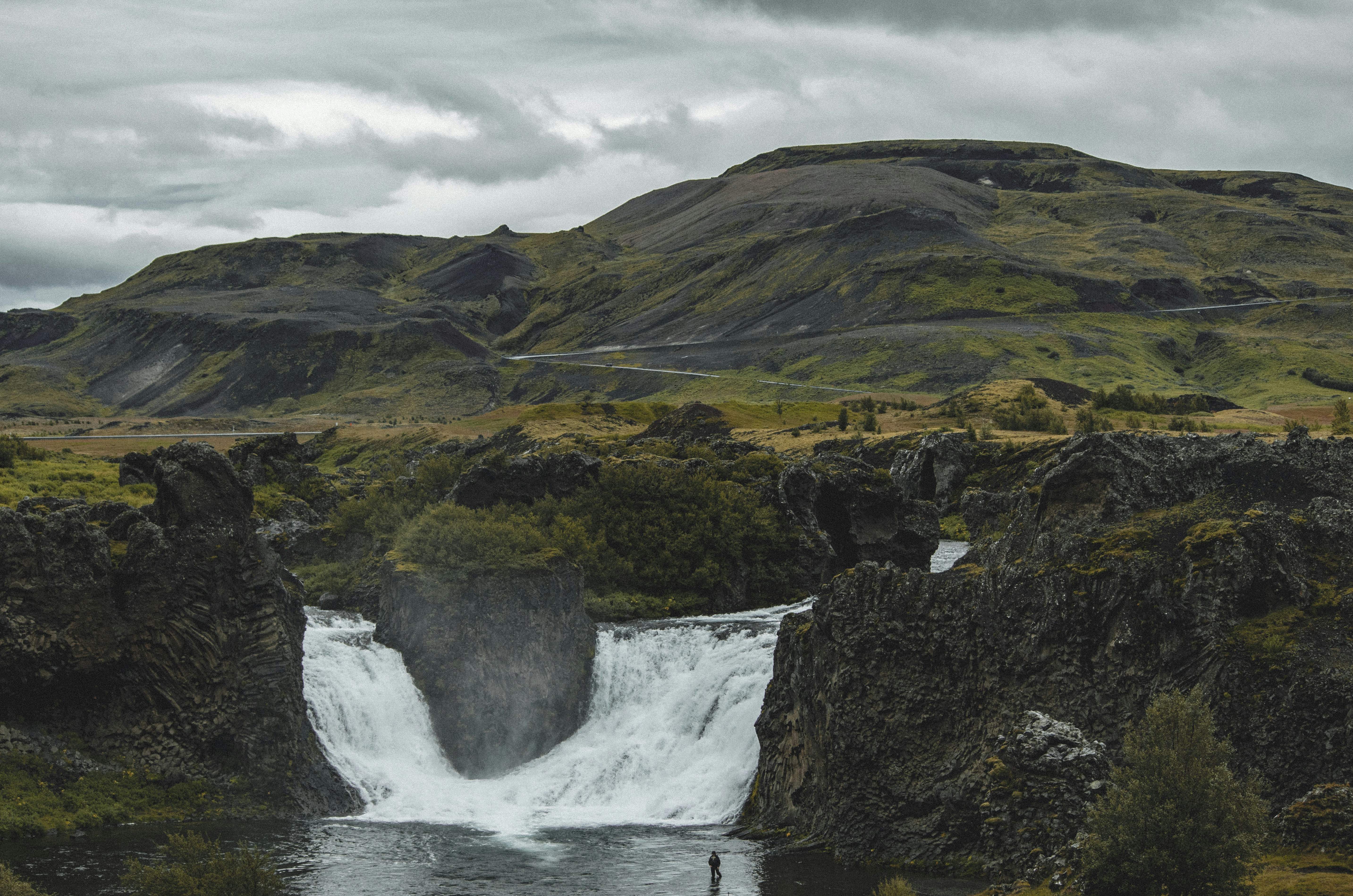 Twin cascades of Hjálparfoss flowing into a shared pool in Iceland.