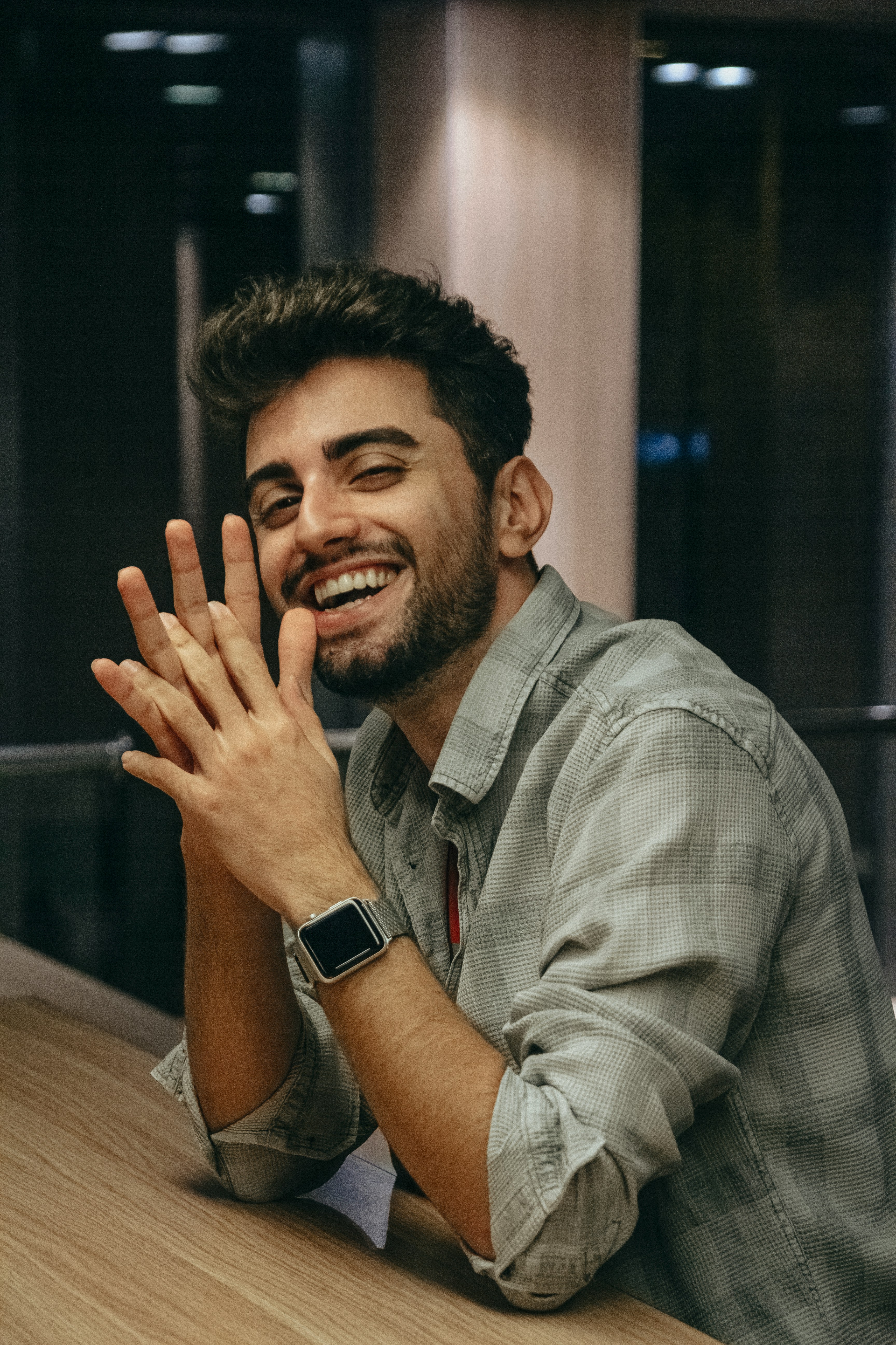 a man smiling and holding his hands up