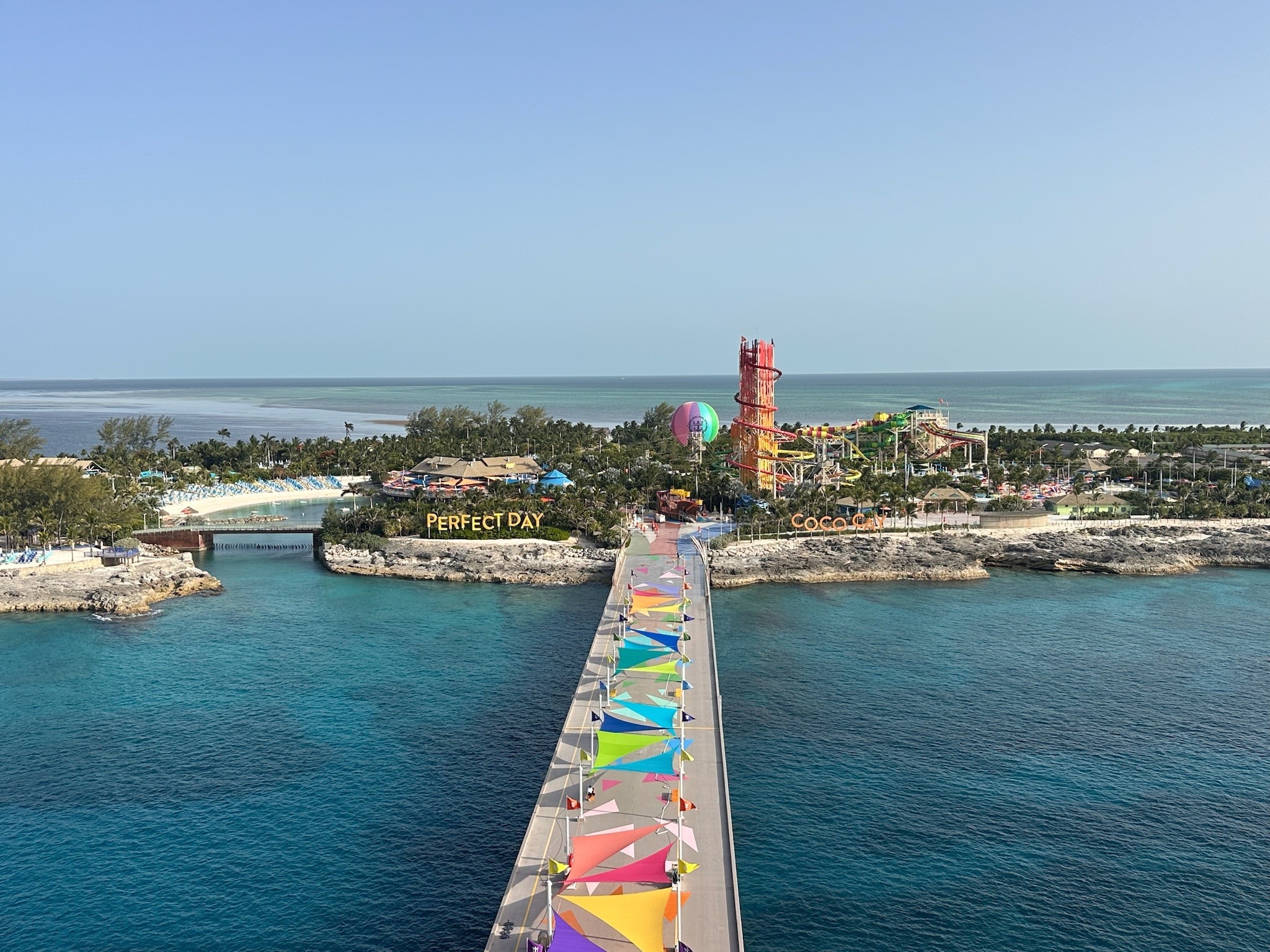 woman in blue tank top standing beside white wall