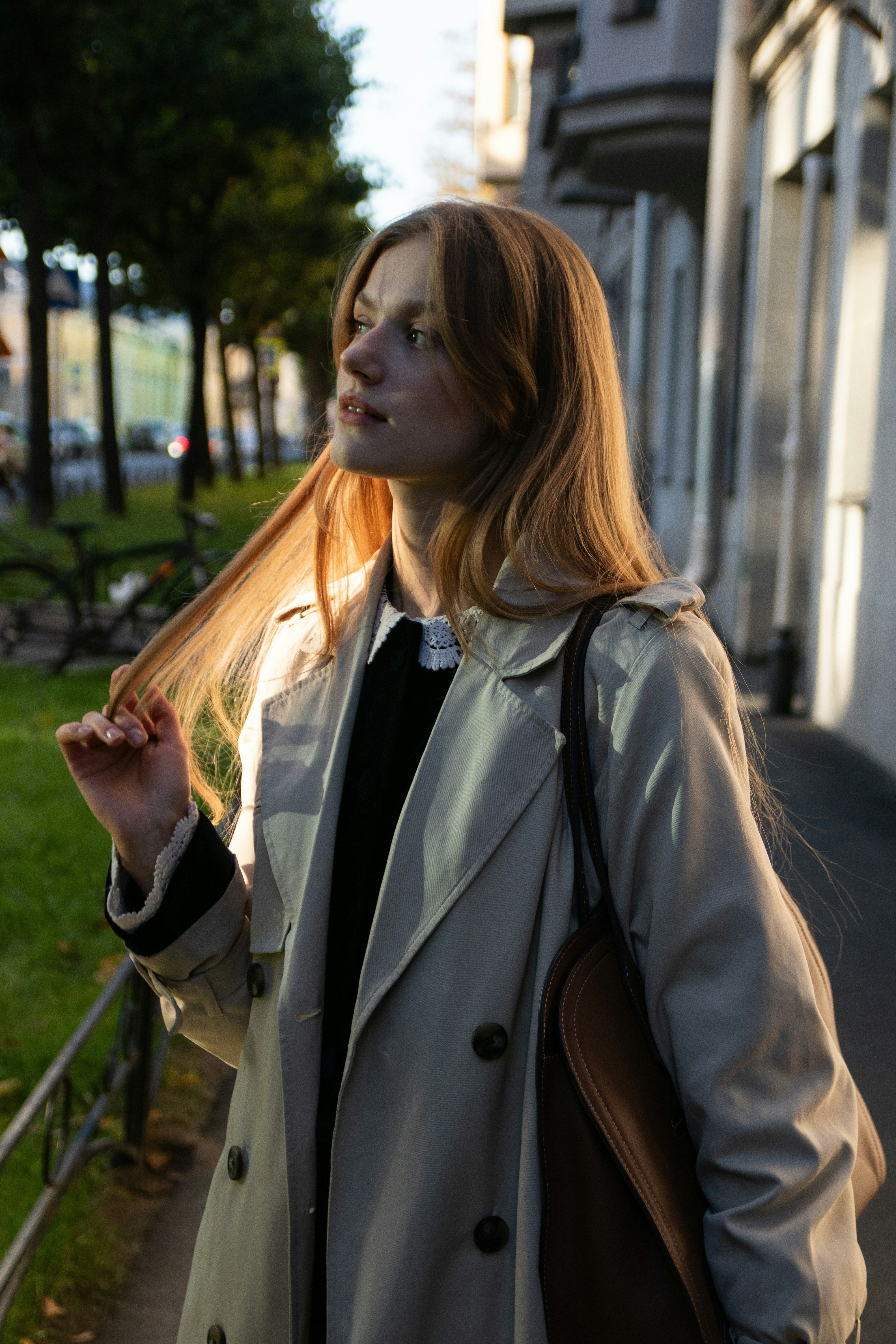 Young woman with long blonde hair in a trench coat