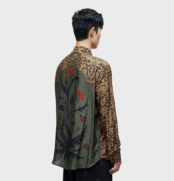 suggest me a good seo based alt text ChatGPT said: "Back view of a male model wearing a long-sleeve shirt with intricate green and gold floral patterns and a large botanical motif. Unique fusion of traditional and contemporary streetwear fashion."