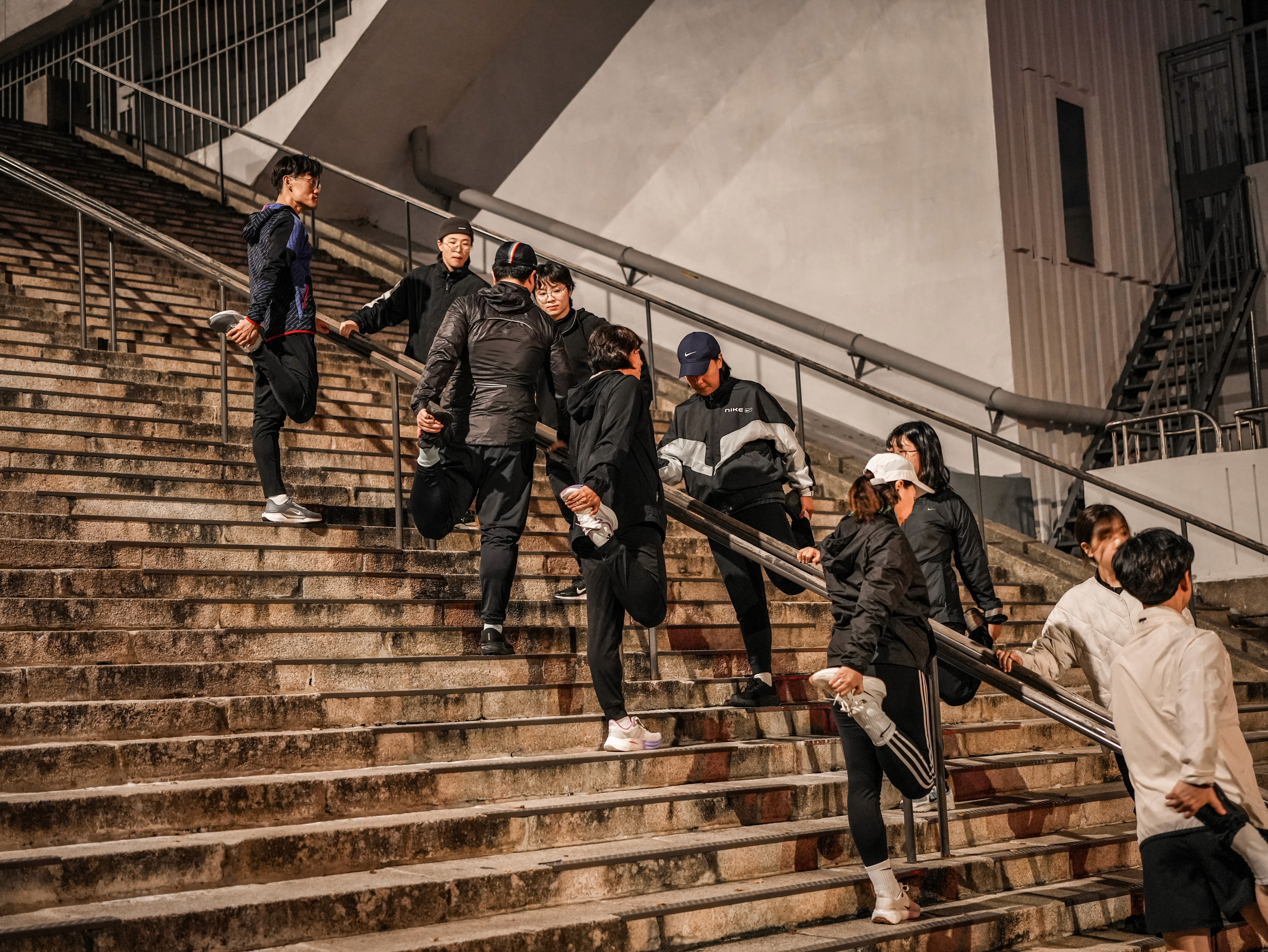 Seoul tower rises behind a bus on the road.