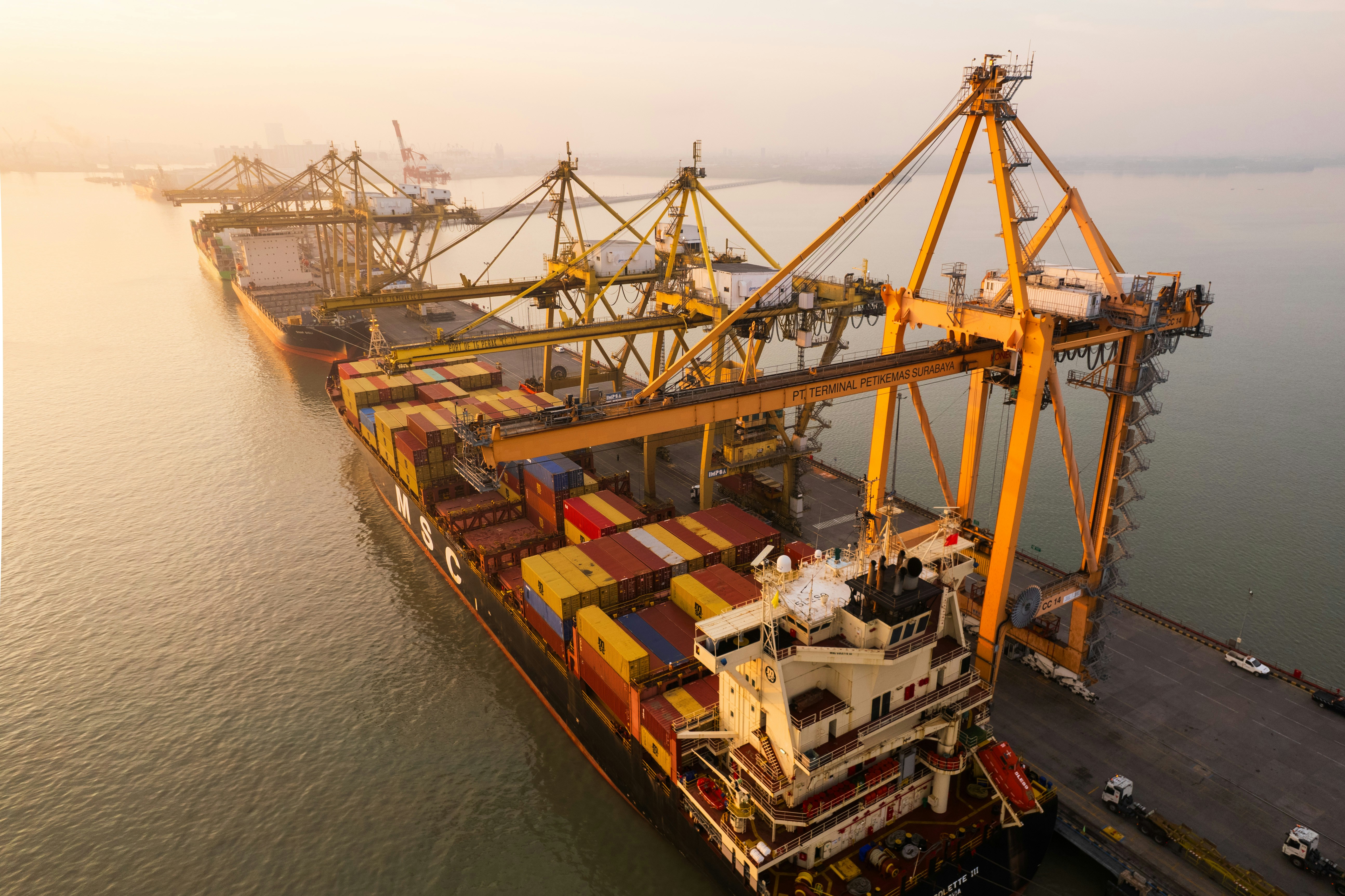 Cargo ship being loaded at a port with cranes