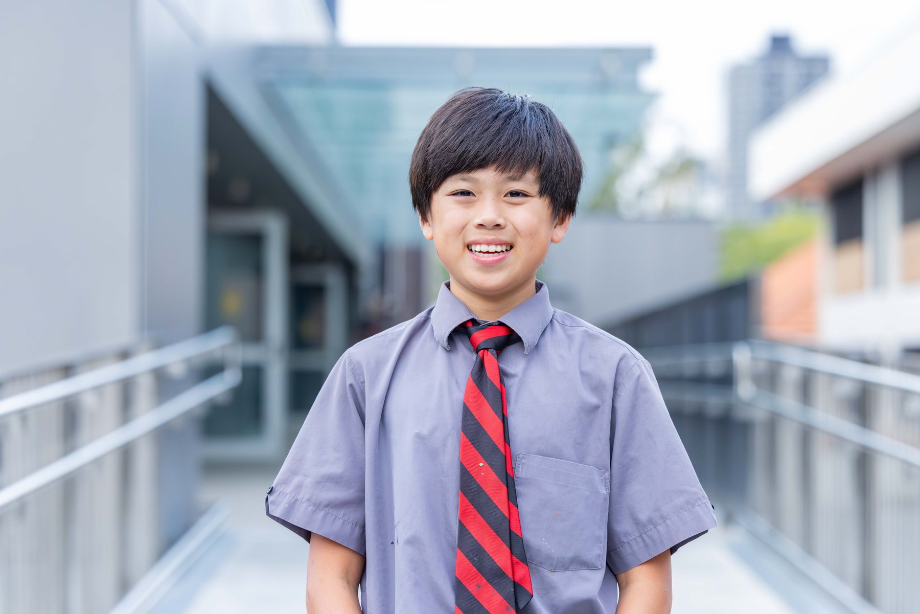 Smiling student in school uniform and tie