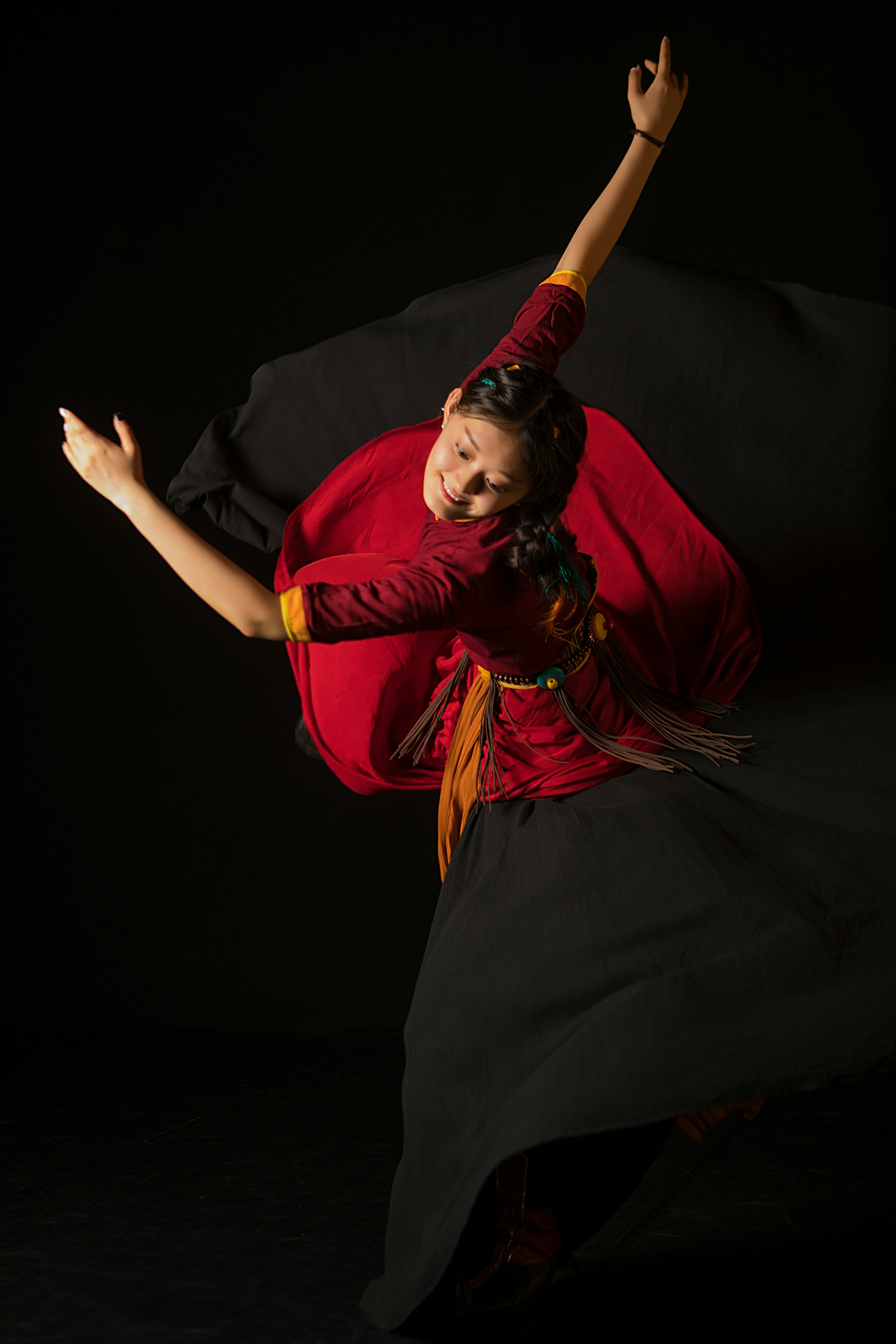 a woman in a red shirt and black skirt