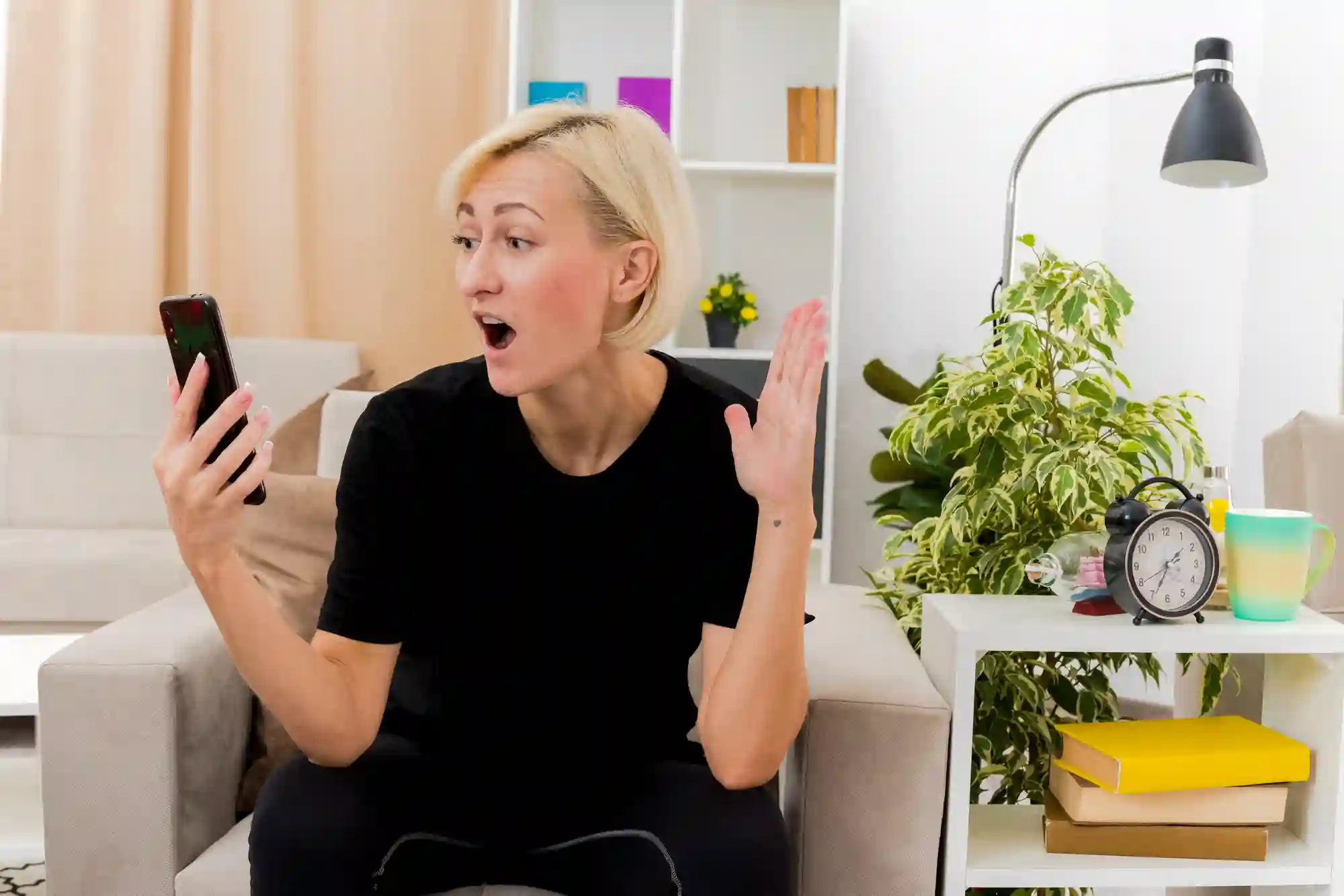 Woman reacts with shock or anger to phone