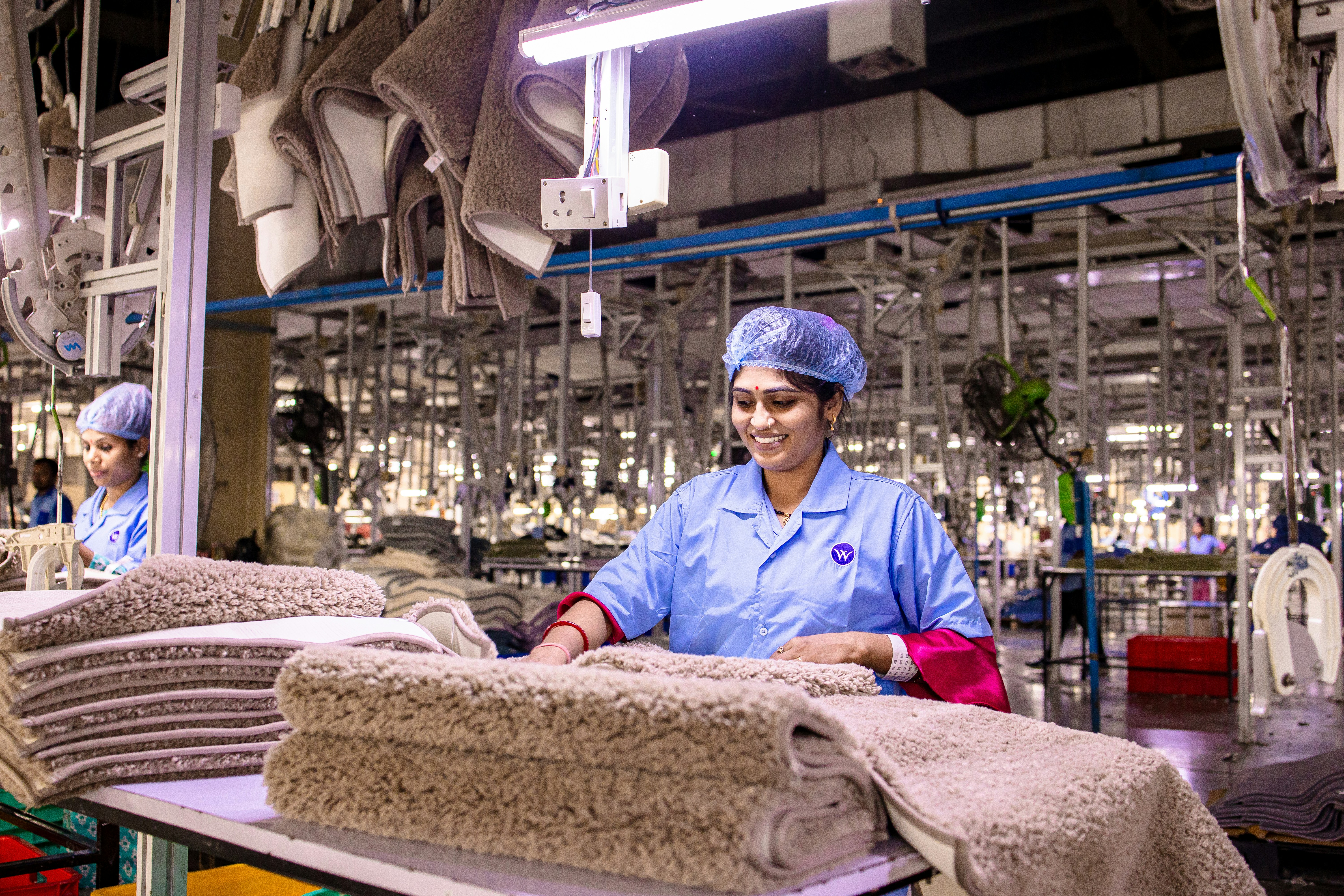 Workers are manufacturing textiles in a factory.