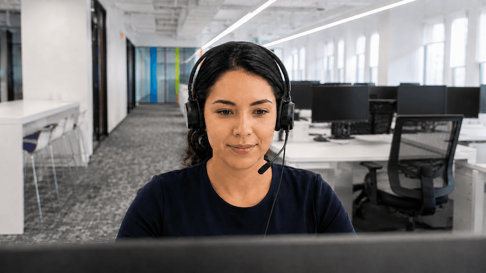 A headset-wearing agent focused on her screen in Gatestone’s contact centre.