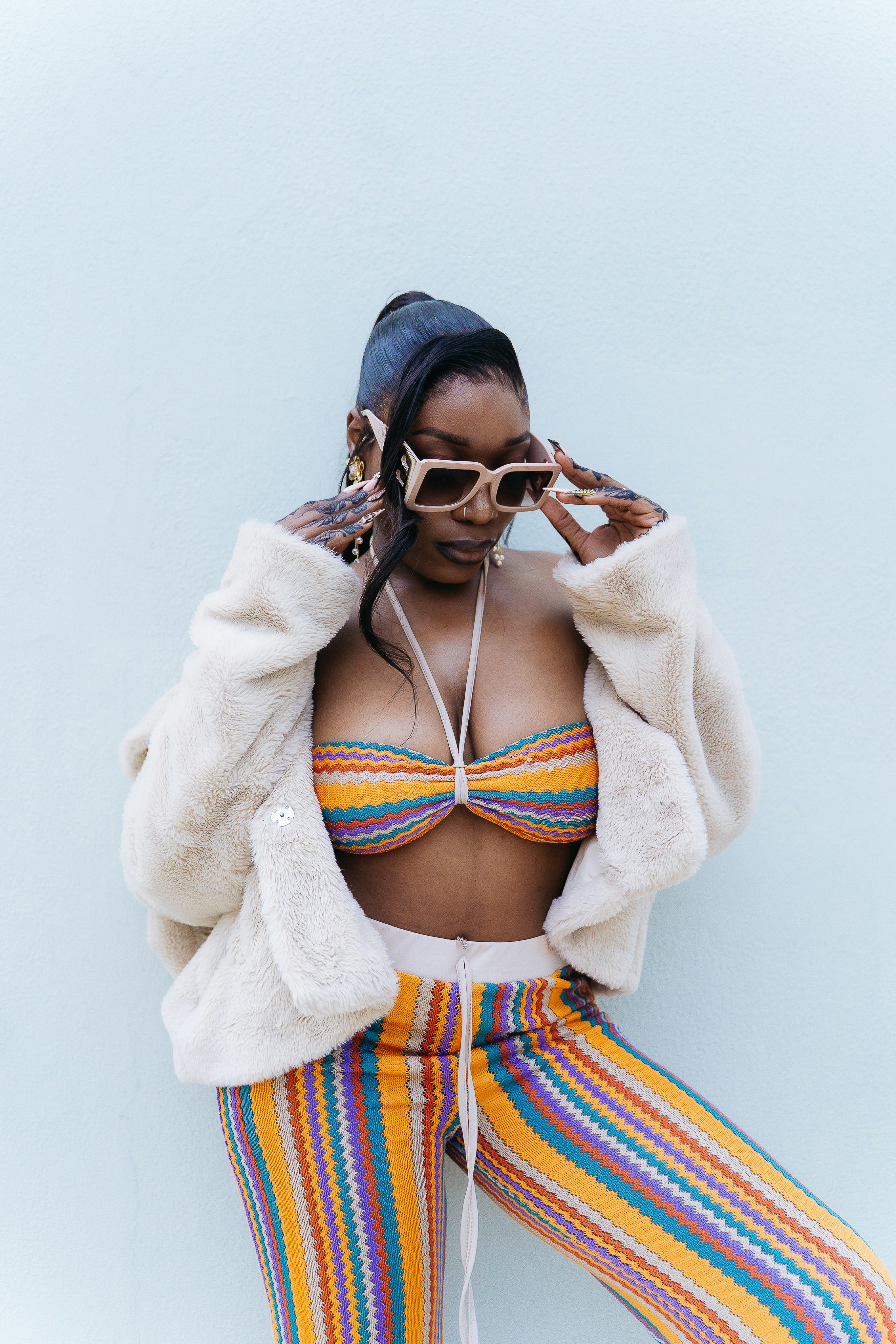 Woman in colorful outfit and sunglasses