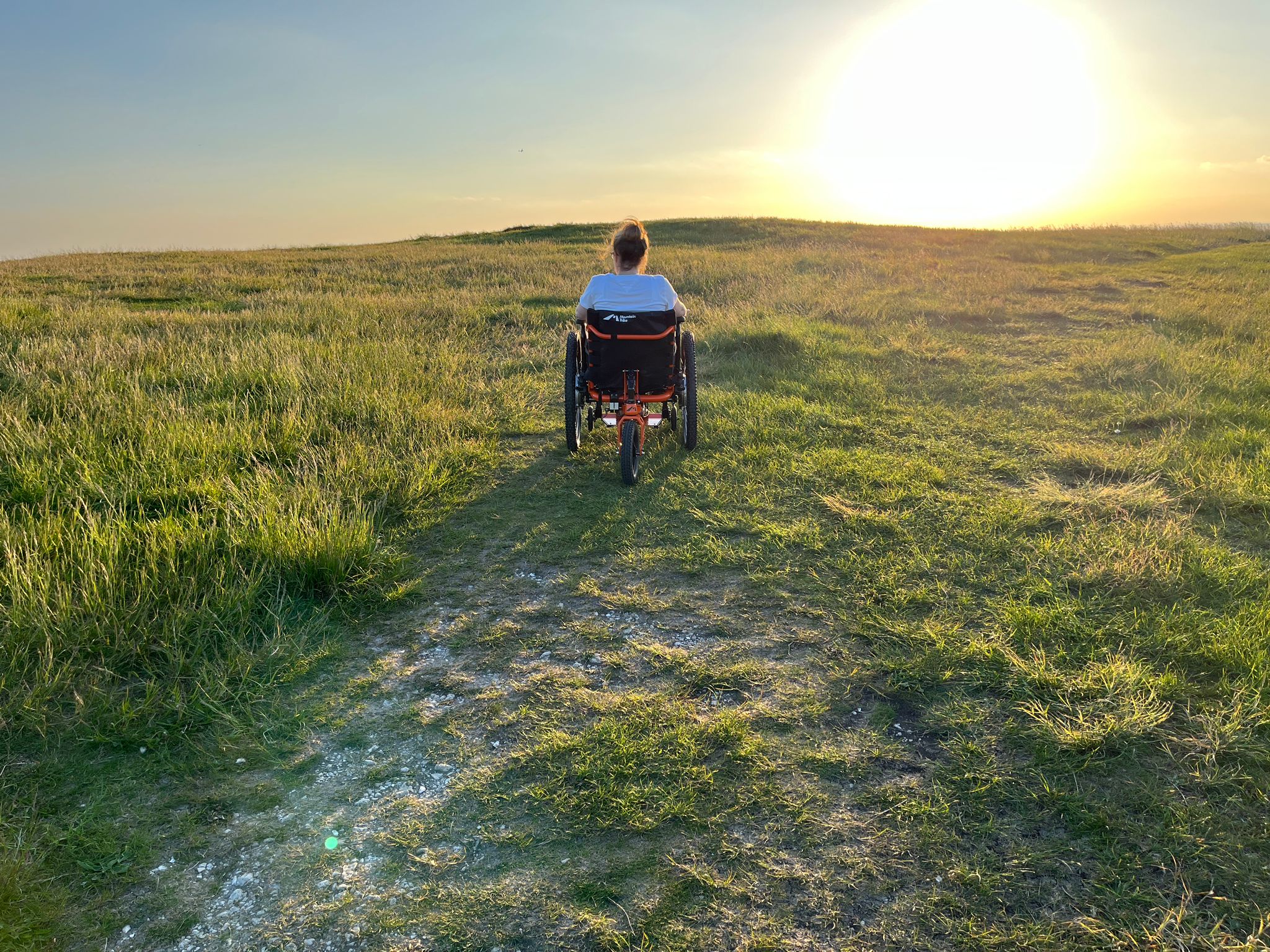 SD Motion range. 16" SD Motion Drive on Little Arc chair, SD Motion Drive on QS 5X wheelchair, and SD Motion Trike, outdoors
