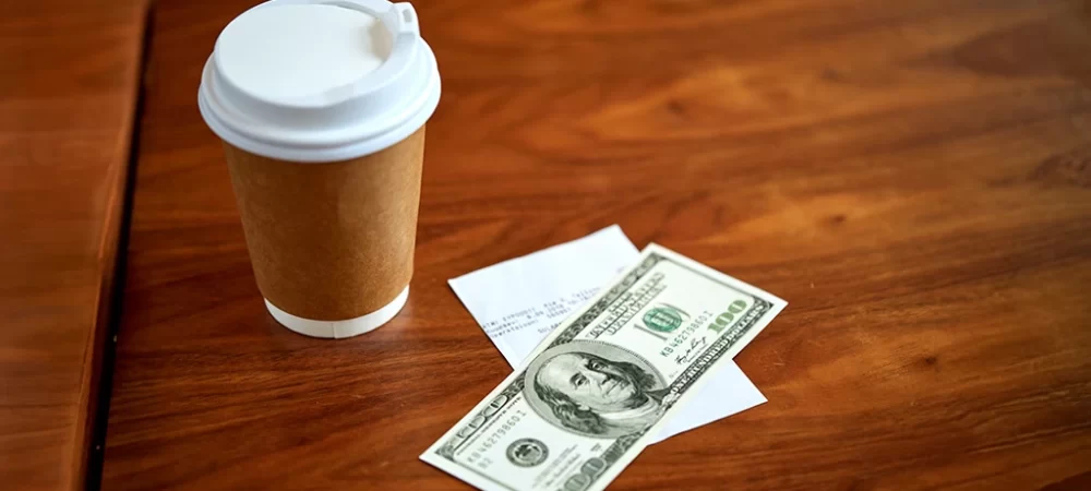 Dollar bill and coffee. Investing can be as simple as buying a coffee