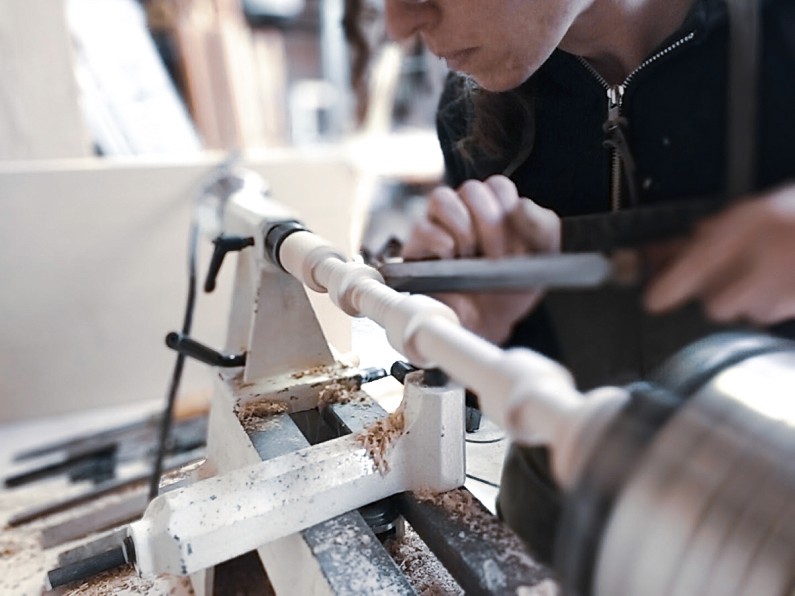 Man working on lathe.
