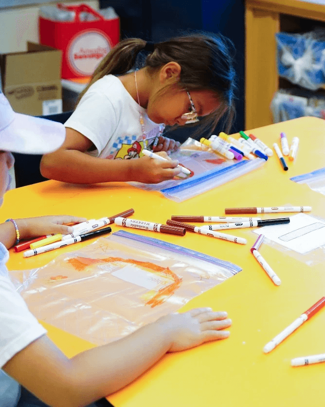A student drawing in a classroom