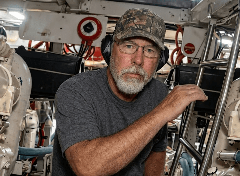 Tom in the engine room of a boat.