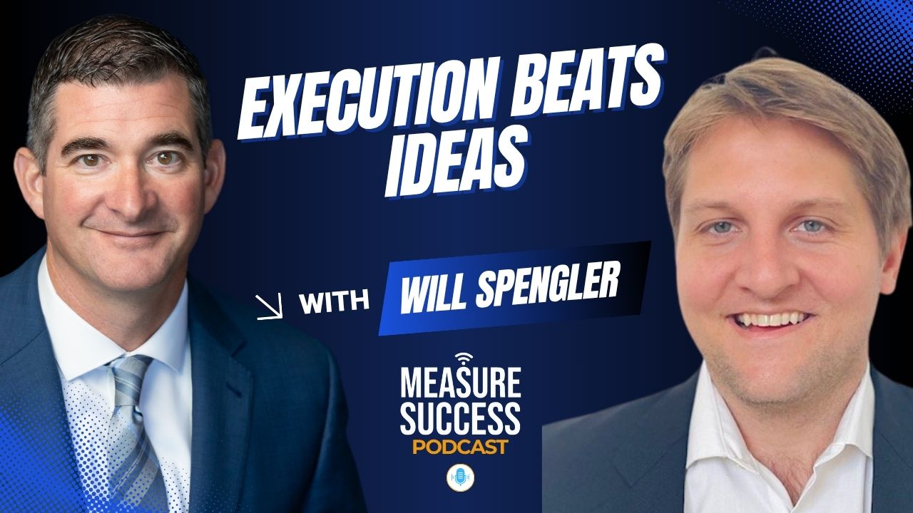 Three colleagues smiling and chatting together in a studio setting.