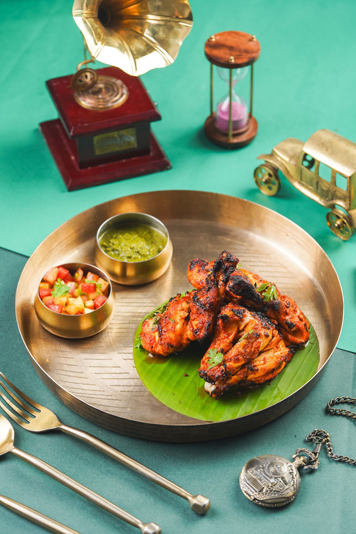 Herb-roasted chicken with baby potatoes and fresh rosemary on a dark plate.