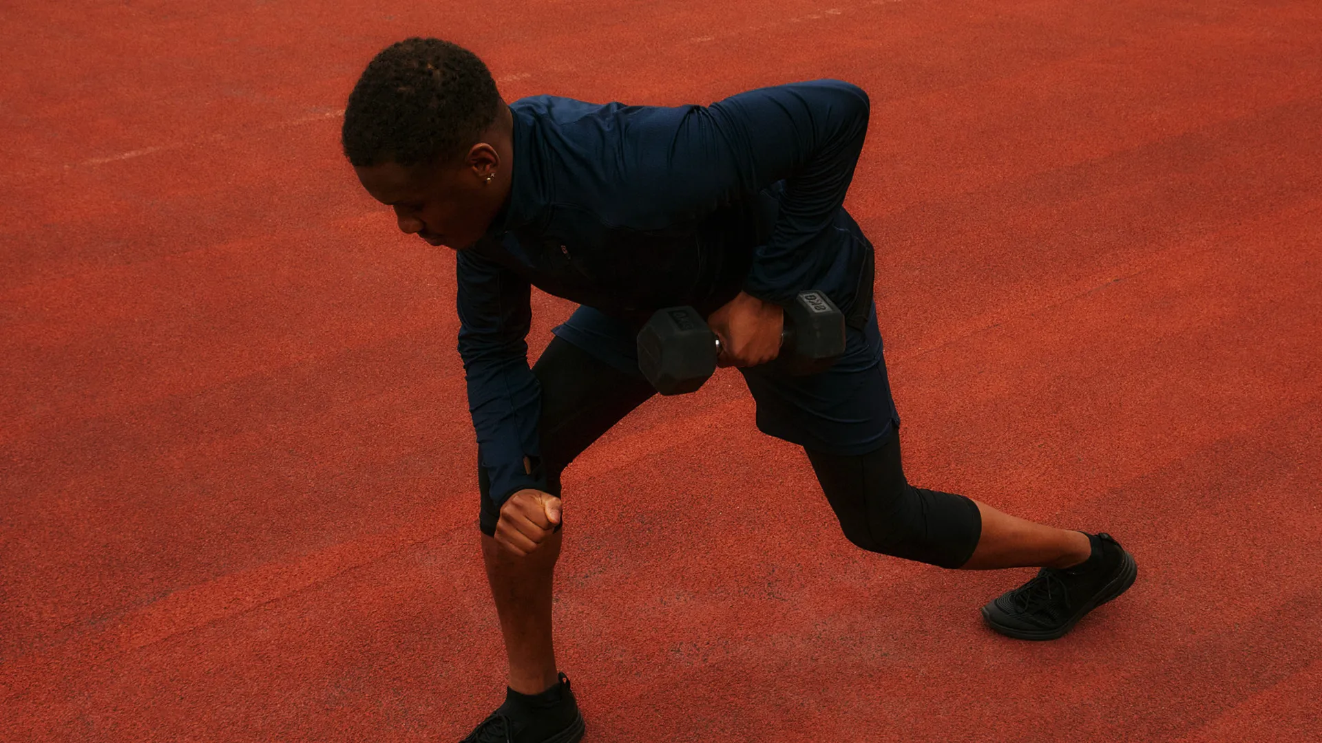 Man performing a dumbbell strength training exercise to improve muscle mass, mobility, and long-term health.